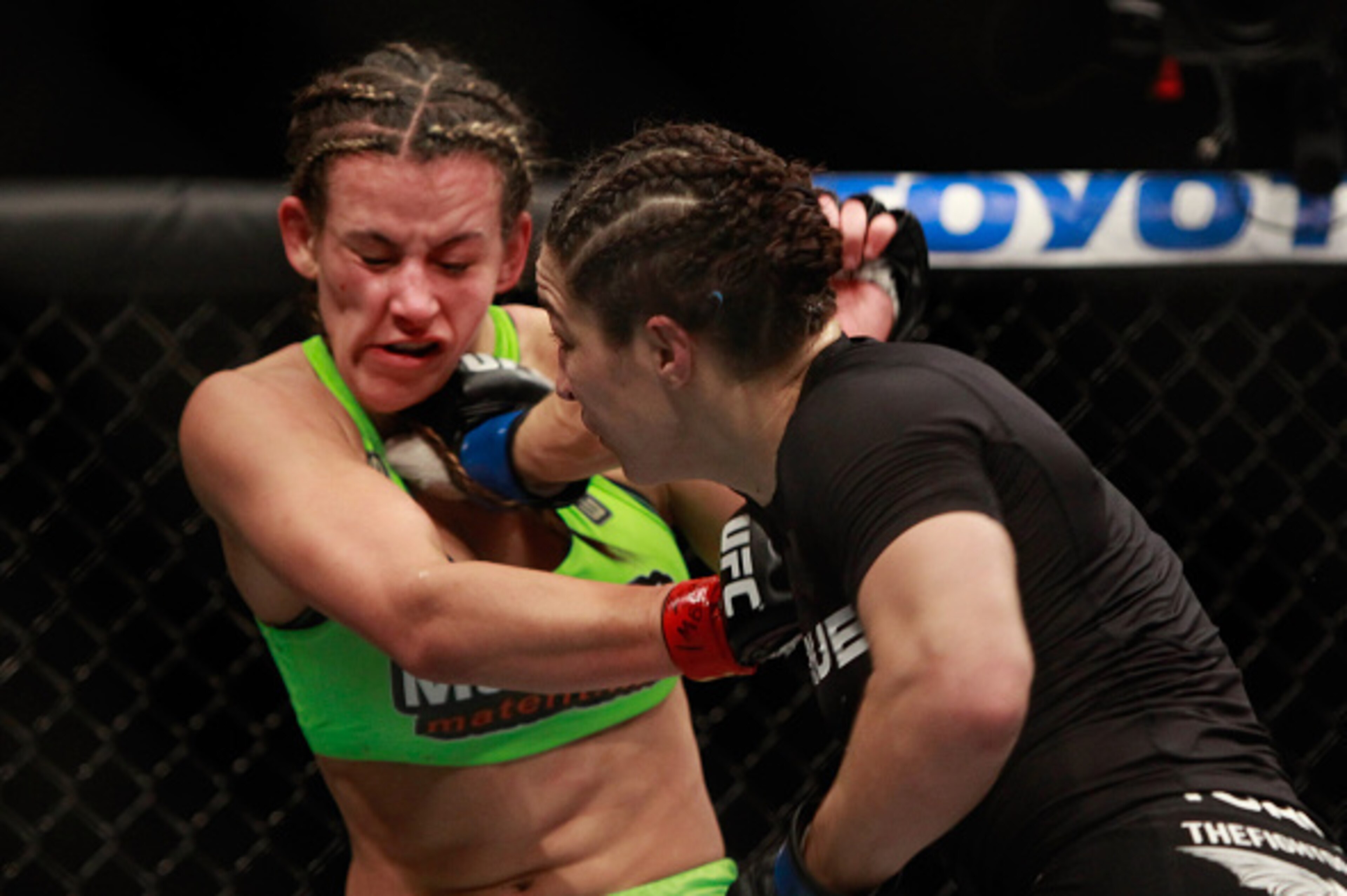 LAS VEGAS, NV - JANUARY 31: Miesha Tate (L) takes a punch from Sara McMann in their bantamweight bout during UFC 183 at the MGM Grand Garden Arena on January 31, 2015 in Las Vegas, Nevada. Tate won the fight by majority decision. (Photo by Steve Marcus/ LAS VEGAS, NV - JANUARY 31: Miesha Tate (L) takes a punch from Sara McMann in their bantamweight bout during UFC 183 at the MGM Grand Garden Arena on January 31, 2015 in Las Vegas, Nevada. Tate won the fight by majority decision. (Photo by Steve Marcus/