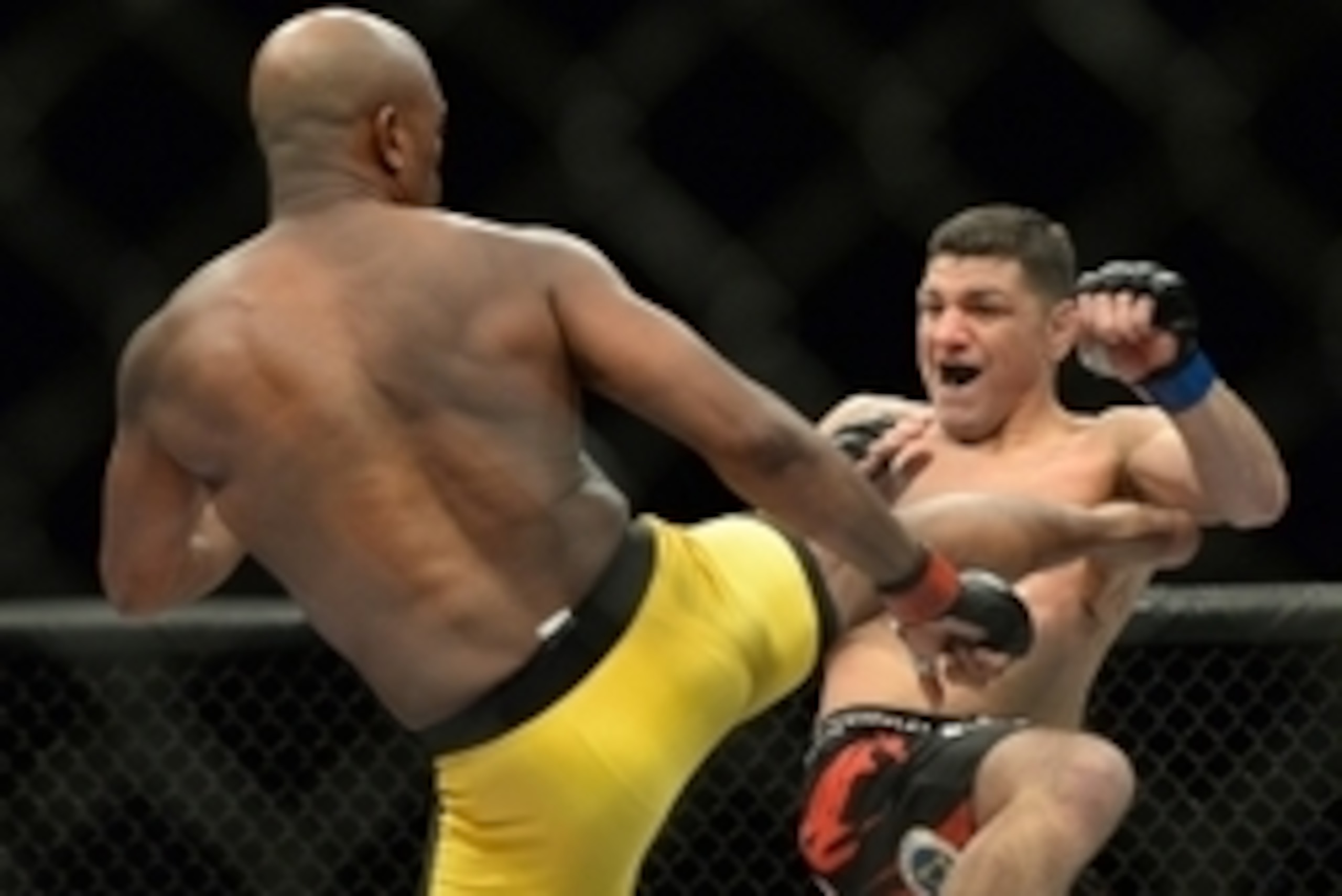 Jan 31, 2015; Las Vegas, NV, USA; Anderson Silva (red gloves) kicks at Nick Diaz (blue gloves) during their middleweight bout during UFC 183 at the MGM Grand Garden Arena. Mandatory Credit: Jayne Kamin-Oncea-USA TODAY Sports