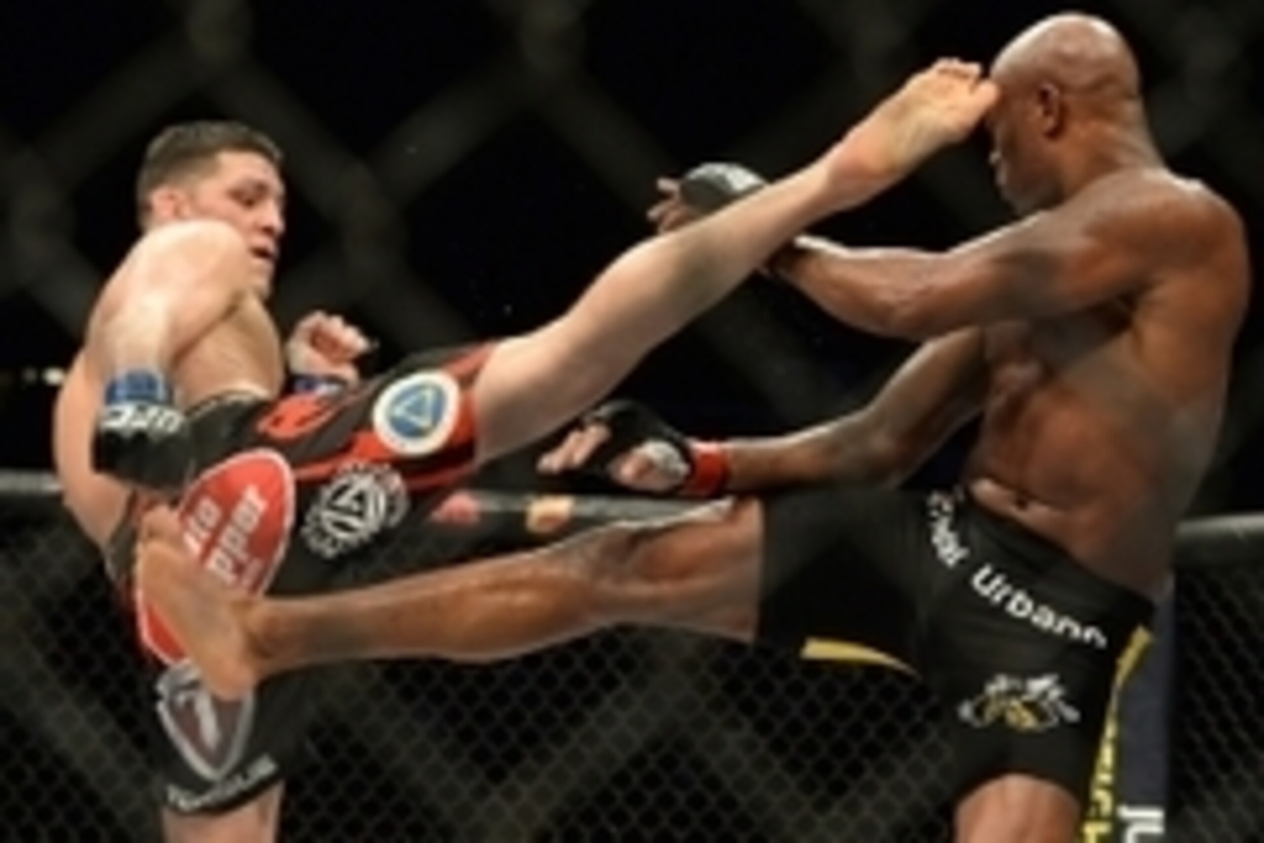 Jan 31, 2015; Las Vegas, NV, USA; Nick Diaz (blue gloves) and Anderson Silva (red gloves) exchange kicks during their middleweight bout during UFC 183 at the MGM Grand Garden Arena. Mandatory Credit: Jayne Kamin-Oncea-USA TODAY Sports