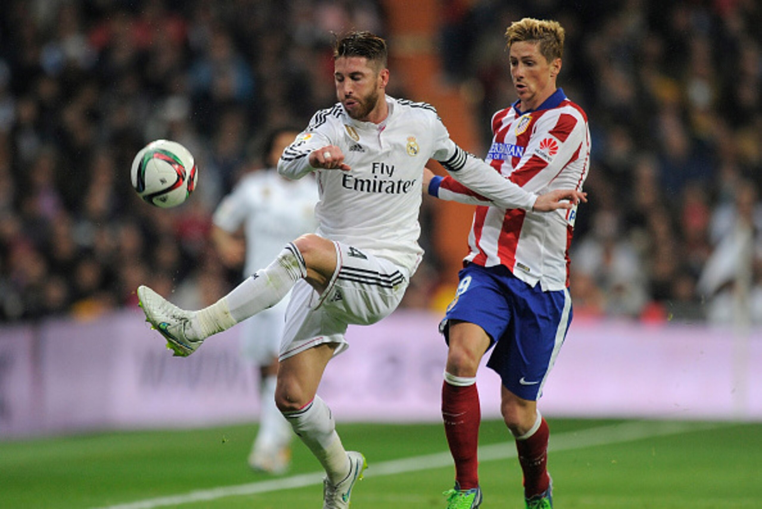 MADRID, SPAIN - JANUARY 15:  Fernando Torres of Atletico de Madrid in action against Sergio Ramos of Real Madrid
during the Copa del Rey Round of 16, Second leg match between Real Madrid and Atletico de Madrid at Estadio Santiago Bernabeu on January 15, 2