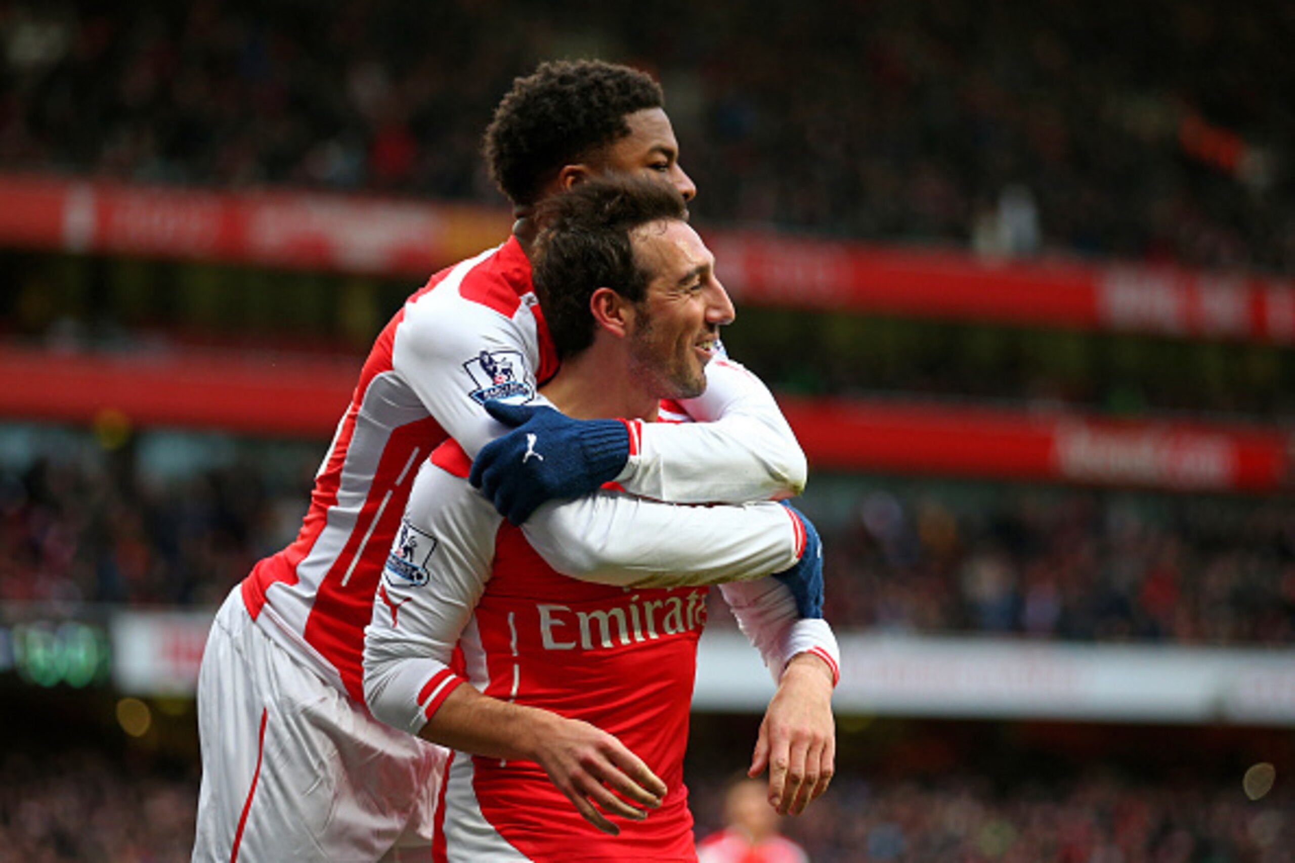 LONDON, ENGLAND - FEBRUARY 01:  Santi Cazorla of Arsenal celebrates with teammate Chuba Akpom of Arsenal after scoring his team's fourth goal from the penalty spot during the Barclays Premier League match between Arsenal and Aston Villa at the Emirates St