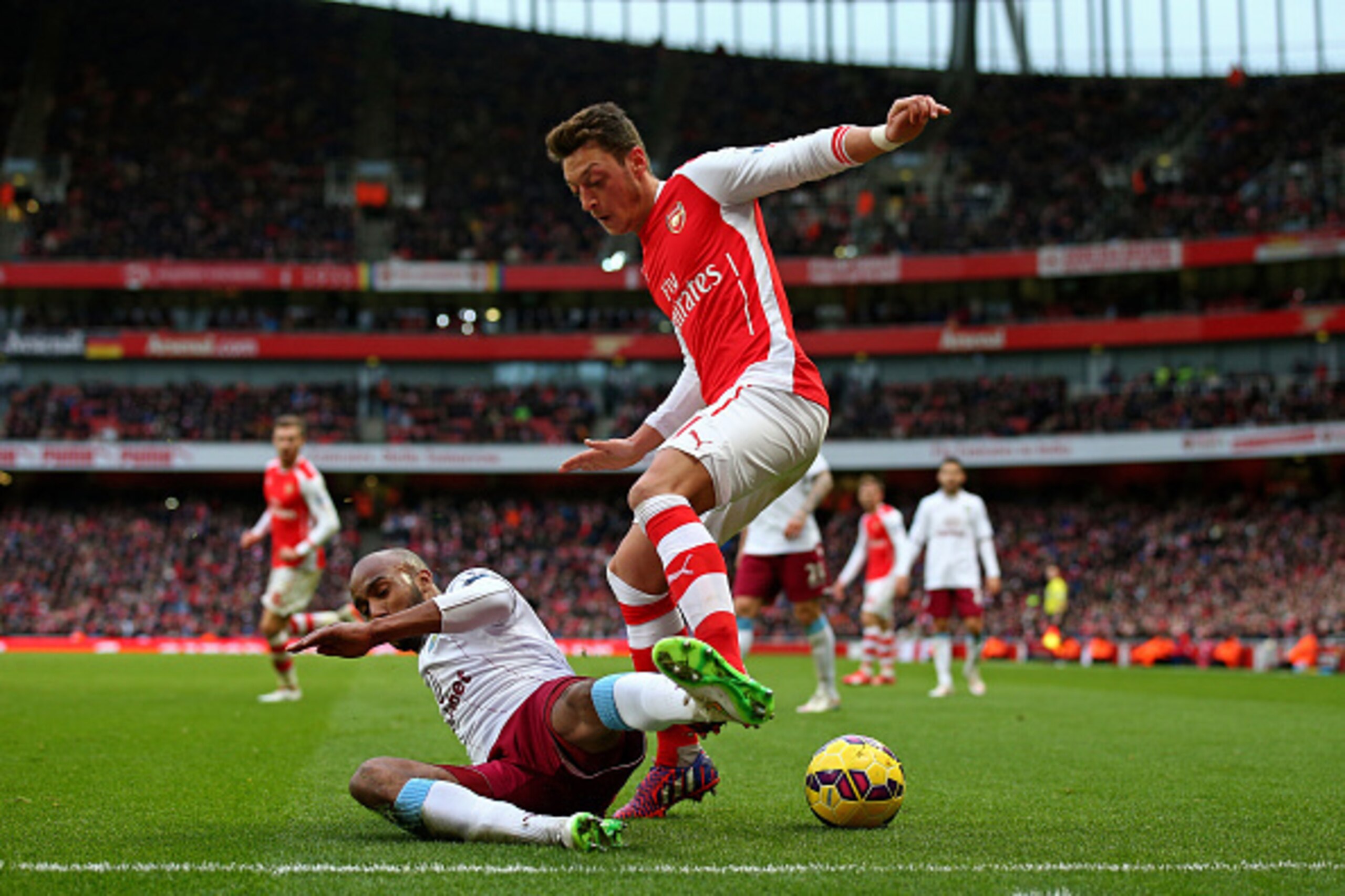 LONDON, ENGLAND - FEBRUARY 01: Mesut Oezil of Arsenal is tackled by Fabian Delph of Aston Villa during the Barclays Premier League match between Arsenal and Aston Villa at the Emirates Stadium on February 1, 2015 in London, England. (Photo by Paul Gilha LONDON, ENGLAND - FEBRUARY 01: Mesut Oezil of Arsenal is tackled by Fabian Delph of Aston Villa during the Barclays Premier League match between Arsenal and Aston Villa at the Emirates Stadium on February 1, 2015 in London, England. (Photo by Paul Gilha