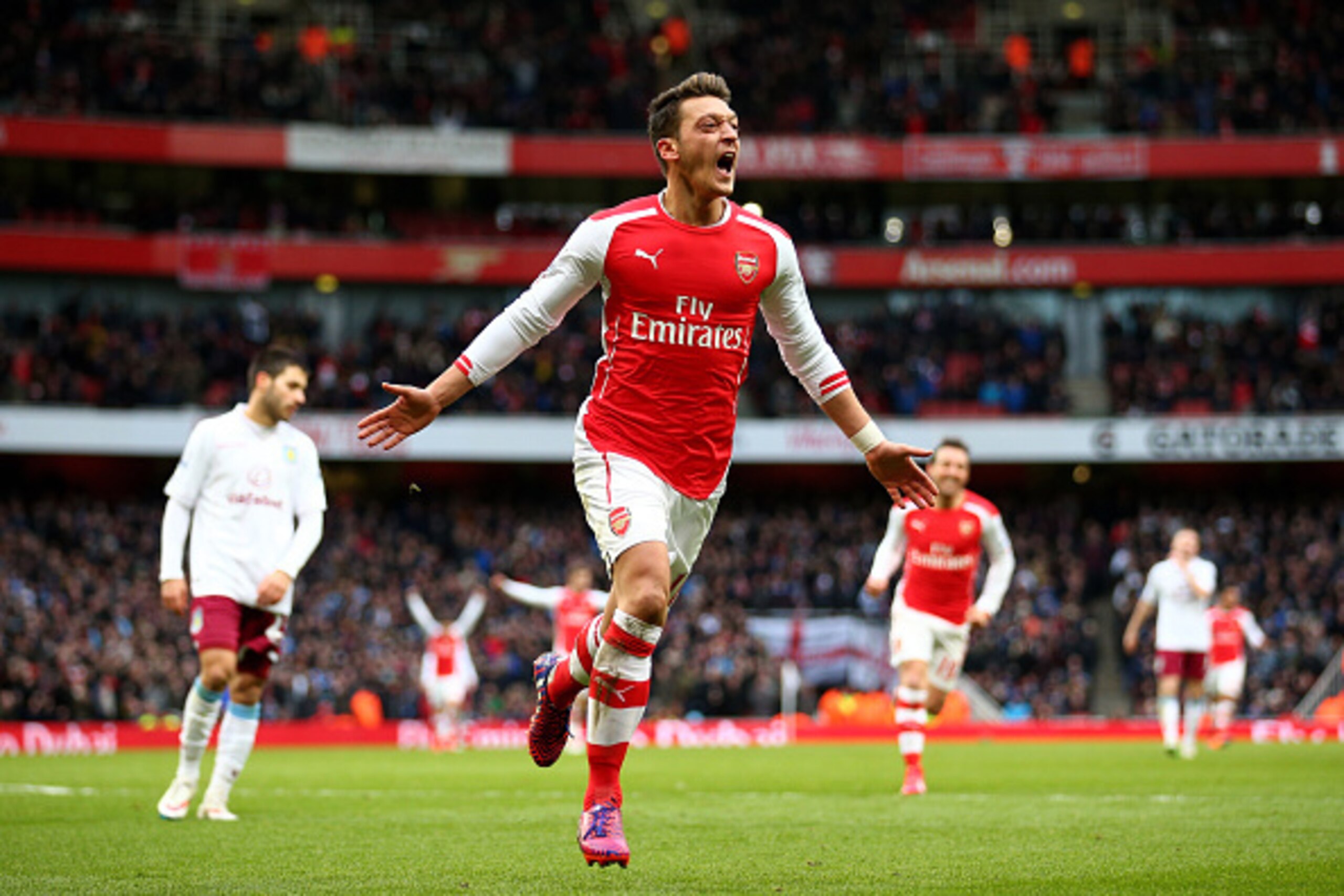 LONDON, ENGLAND - FEBRUARY 01:  Mesut Oezil of Arsenal celebrates after scoring his team's second goal during the Barclays Premier League match between Arsenal and Aston Villa at the Emirates Stadium on February 1, 2015 in London, England.  (Photo by Paul