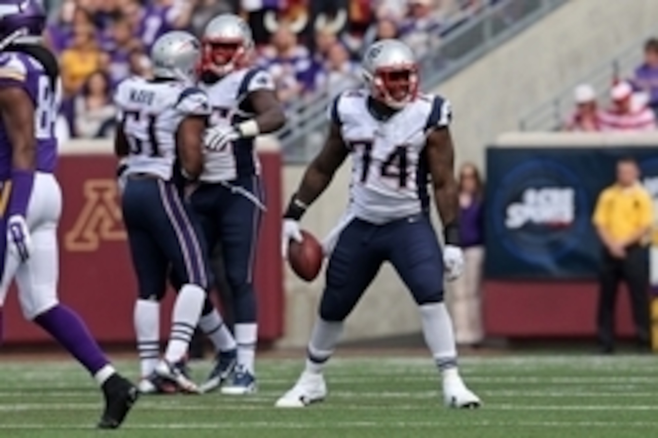 Sep 14, 2014; Minneapolis, MN, USA; New England Patriots defensive tackle Dominique Easley (74) celebrates his interception during the fourth quarter against the Minnesota Vikings at TCF Bank Stadium. The Patriots defeated the Vikings 30-7. Mandatory Cred