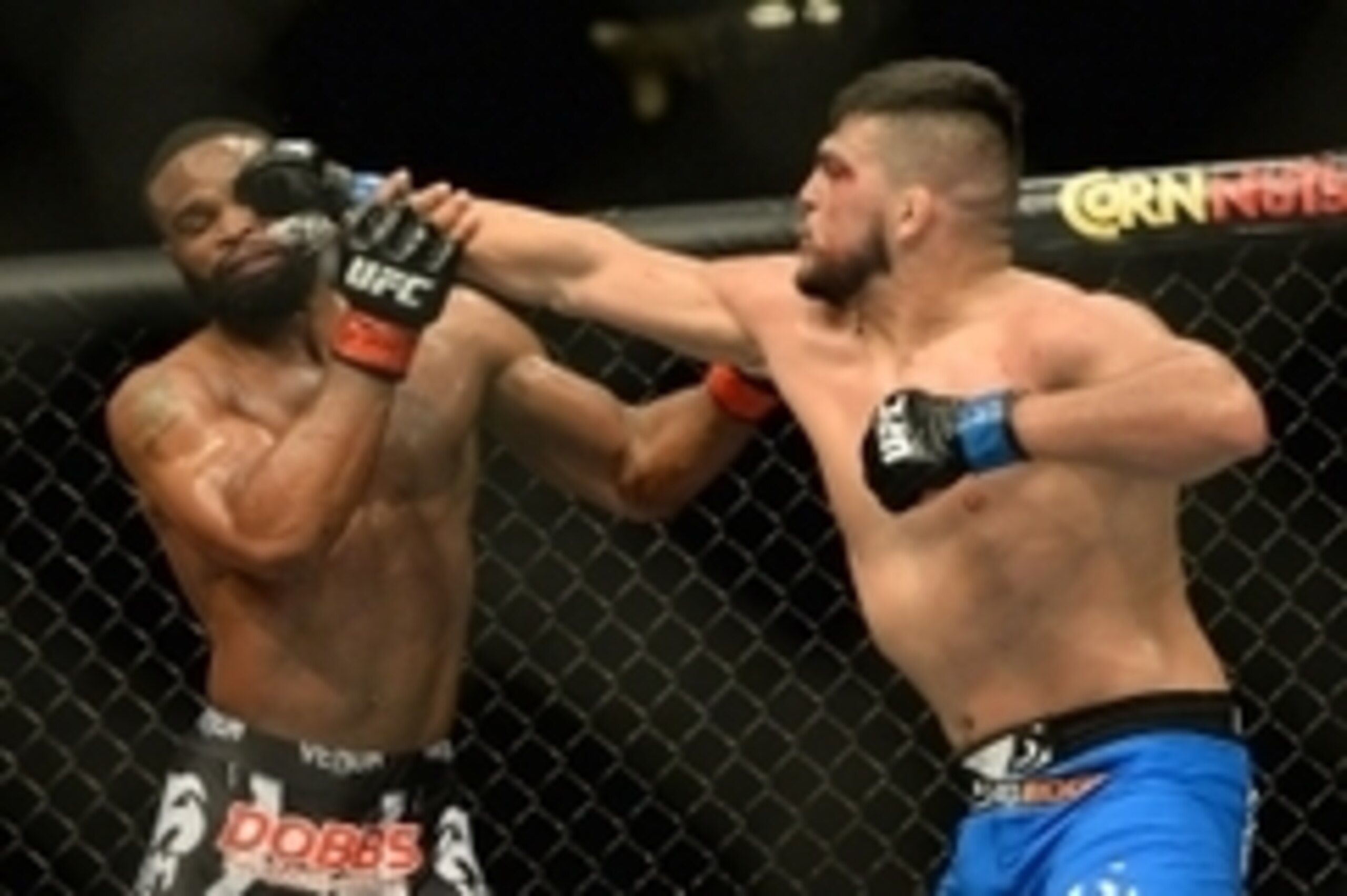 Jan 31, 2015; Las Vegas, NV, USA; Tyrone Woodley (red gloves) takes a punch from Kelvin Gastelum (blue gloves) during their welterweight bout during UFC 183 at the MGM Grand Garden Arena. Mandatory Credit: Jayne Kamin-Oncea-USA TODAY Sports
