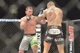 Aug 16, 2014; Bangor, ME, USA; Gray Maynard (red gloves) fights Ross Pearson (blue gloves) during lightweight bout at Cross Insurance Center. Mandatory Credit: Gregory J. Fisher-USA TODAY Sports