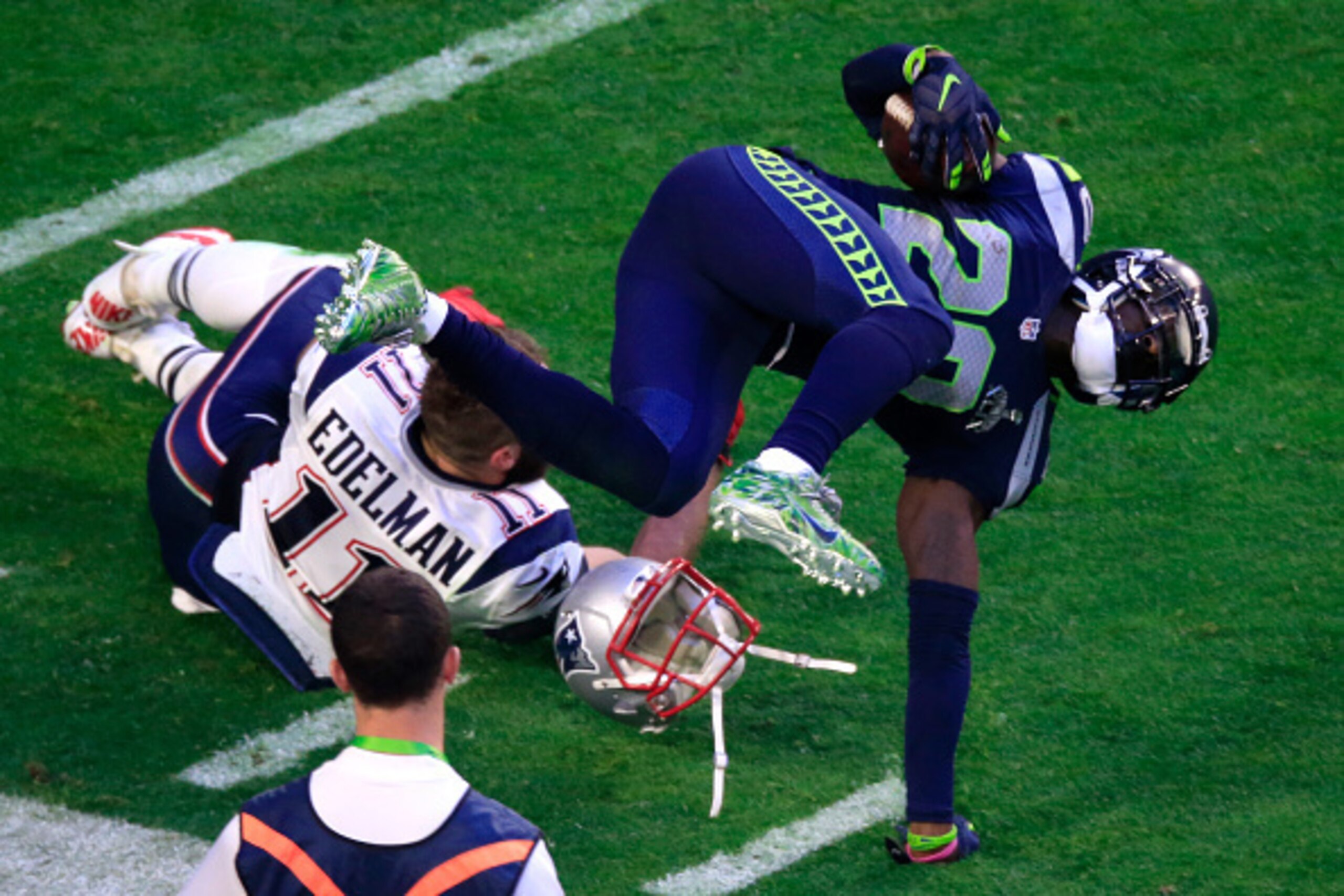 GLENDALE, AZ - FEBRUARY 01:  Julian Edelman #11 of the New England Patriots tackles Jeremy Lane #20 of the Seattle Seahawks after an interception in the first quarter during Super Bowl XLIX at University of Phoenix Stadium on February 1, 2015 in Glendale,