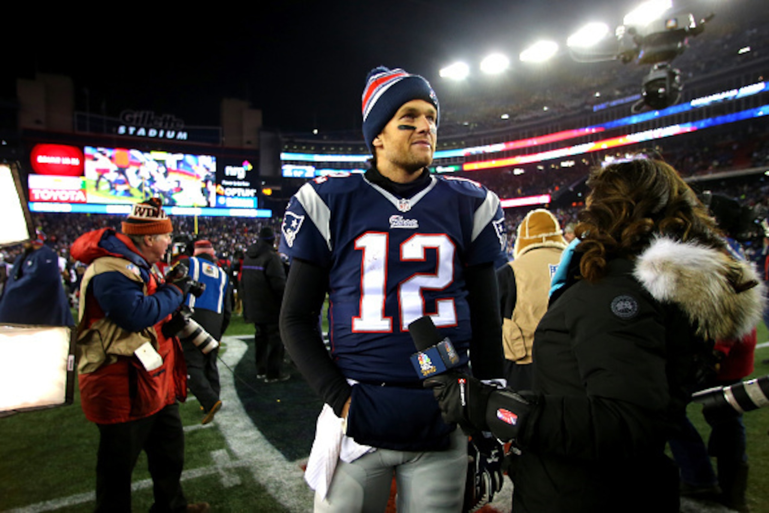 FOXBORO, MA - JANUARY 10:  Tom Brady #12 of the New England Patriots speaks to media after defeating the Baltimore Ravens during the 2015 AFC Divisional Playoffs game at Gillette Stadium on January 10, 2015 in Foxboro, Massachusetts.  (Photo by Elsa/Getty