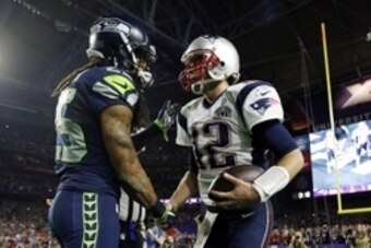 Feb 1, 2015; Glendale, AZ, USA; Seattle Seahawks cornerback Richard Sherman (left) shakes hands with New England Patriots quarterback Tom Brady (12) after Super Bowl XLIX at University of Phoenix Stadium. Mandatory Credit: Mark J. Rebilas-USA TODAY Sports
