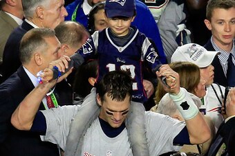 GLENDALE, AZ - FEBRUARY 01:  Tom Brady #12 of the New England Patriots celebrates with his son Benjamin after defeating the Seattle Seahawks during Super Bowl XLIX at University of Phoenix Stadium on February 1, 2015 in Glendale, Arizona. The Patriots def