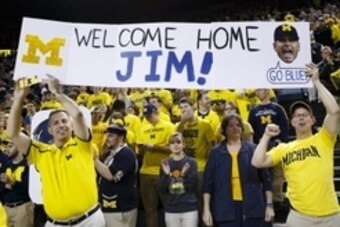 Dec 30, 2014; Ann Arbor, MI, USA; Fans hold up a sign for new Michigan Wolverines head football coach Jim Harbaugh during halftime of the basketball game against the Illinois Fighting Illini at Crisler Center. Mandatory Credit: Rick Osentoski-USA TODAY Sp