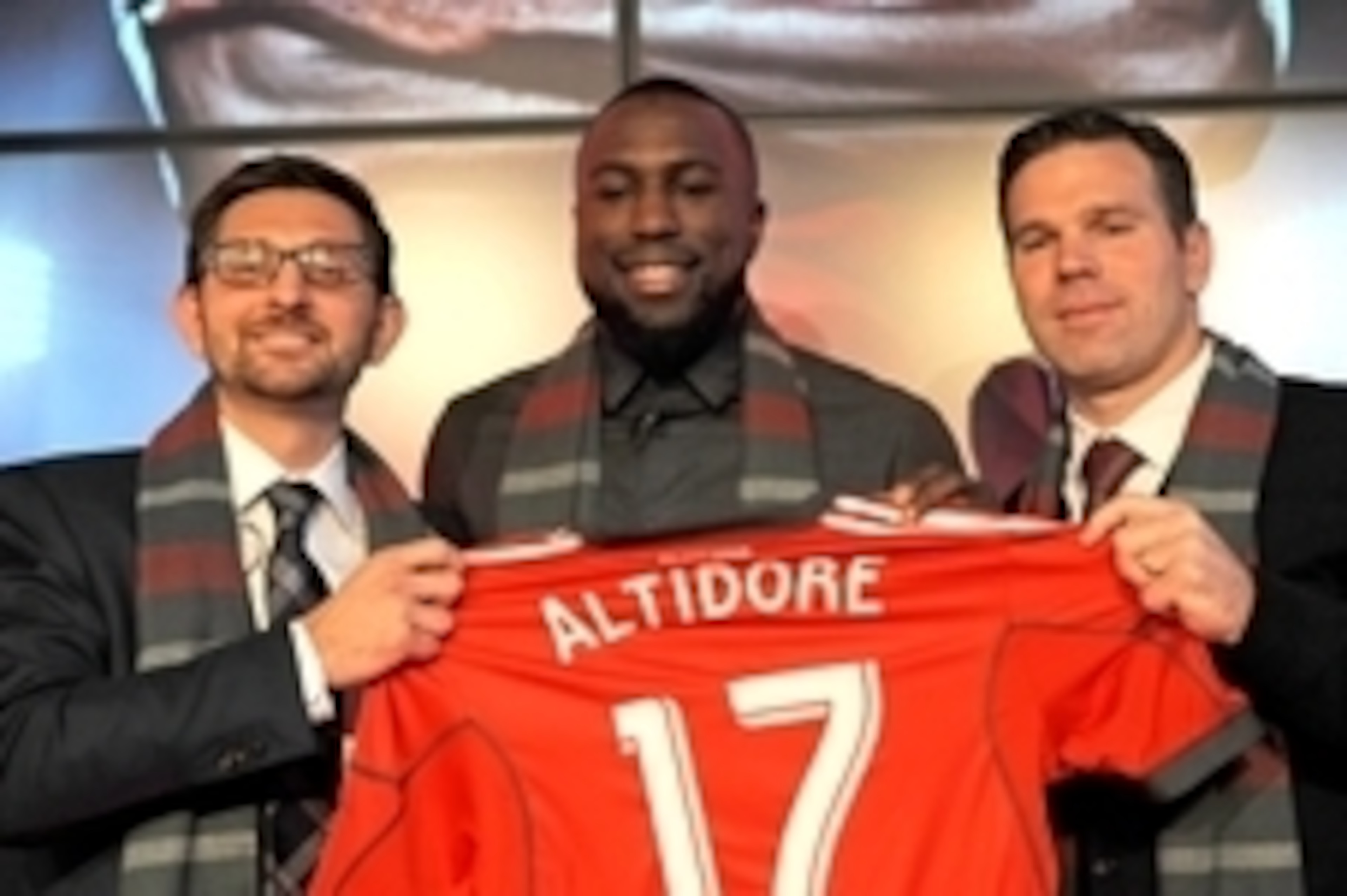 Jan 16, 2015; Toronto, ON, Canada;  Toronto FC striker Jozy Altidore is presented with his Toronto FC team jersey by club general manager Tim Bezbatchenko (left) and head coach Greg Vanney (right) during a media conference at Air Canada Centre. Mandatory 