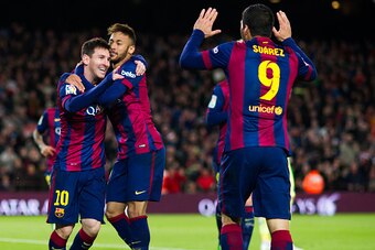 BARCELONA, SPAIN - DECEMBER 07: Lionel Messi (L) of FC Barcelona celebrates with his teammates Neymar Santos Jr (C) and Luis Suarez (R) after scoring his second team's goal during the La Liga match between FC Barcelona and RCD Espanyol at Camp Nou on Dece