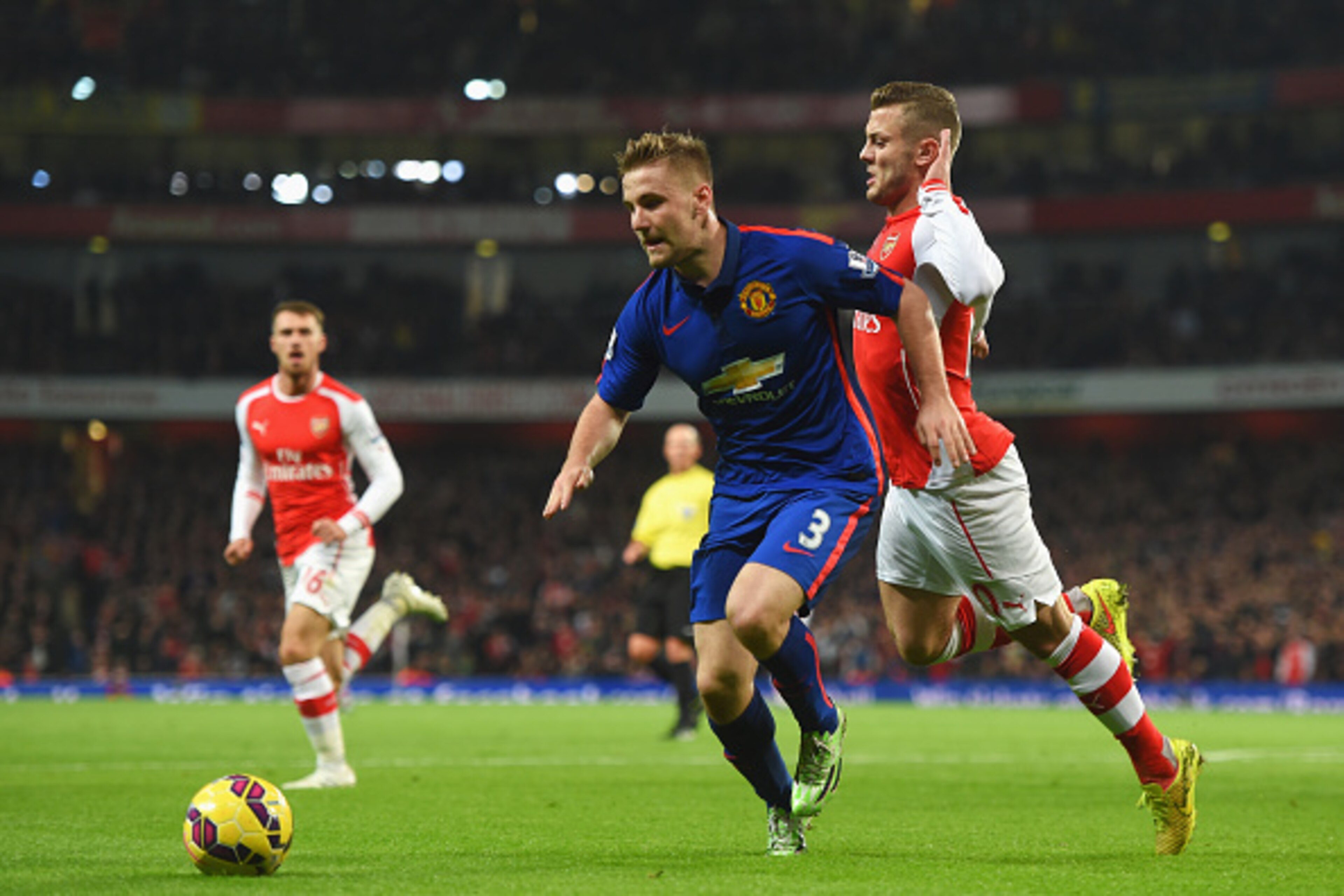 LONDON, ENGLAND - NOVEMBER 22:  Jack Wilshere of Arsenal challenges Luke Shaw of Manchester United during the Barclays Premier League match between Arsenal and Manchester United at Emirates Stadium on November 22, 2014 in London, England.  (Photo by Micha