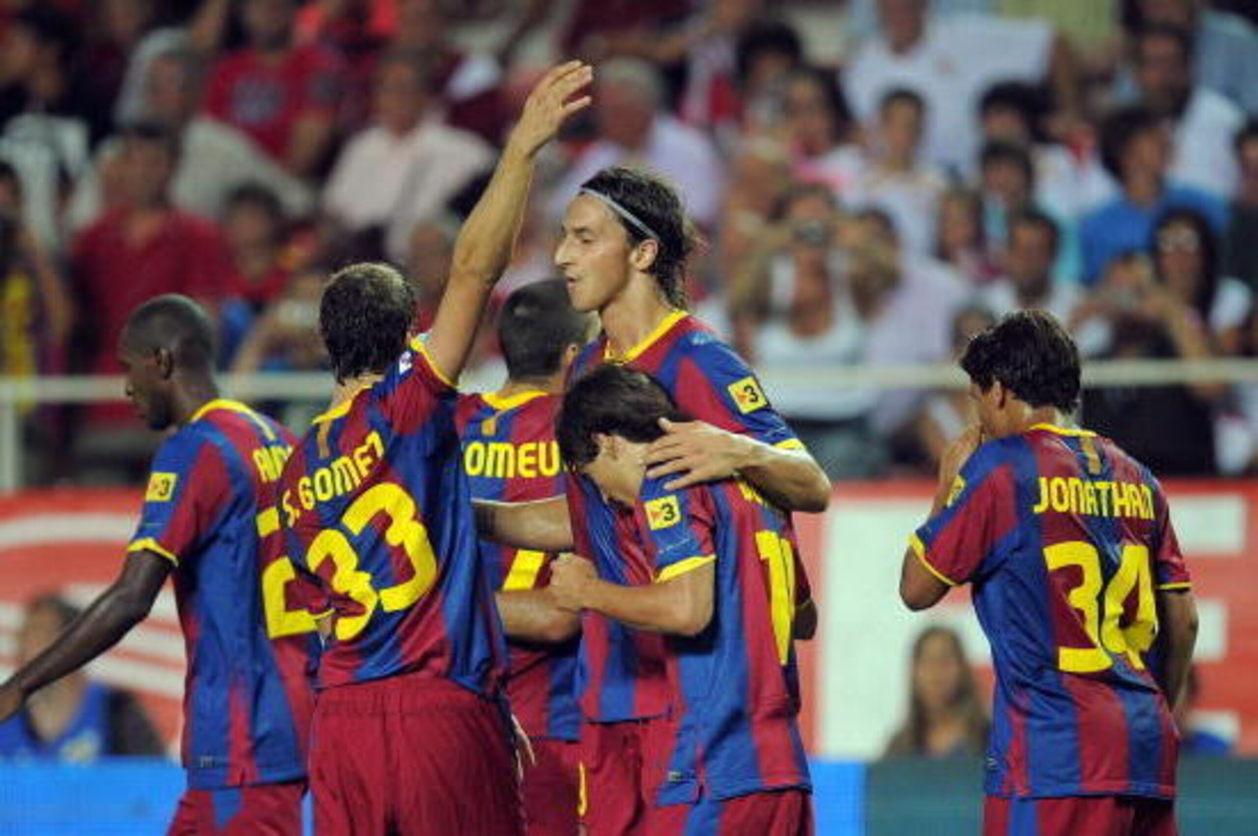 SEVILLE, SPAIN - AUGUST 14:  : Zlatan Ibrahimovic (C) of Barcelona celebrates with teammates after scoring a goal during the Supercopa, first leg, match between Sevilla and Barcelona at the Sanchez Pizjuan stadium  on August 14, 2010 in Seville, Spain.  (