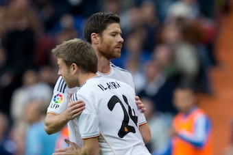 MADRID, SPAIN - NOVEMBER 09: Asier Illarramendi (R) of Real Madrid CF relevates his teammate Xabi Alonso (L) during the La Liga match between Real Madrid CF and Real Sociedad de Futbol  at Estadio Santiago Bernabeu on November 9, 2013 in Madrid, Spain.  (