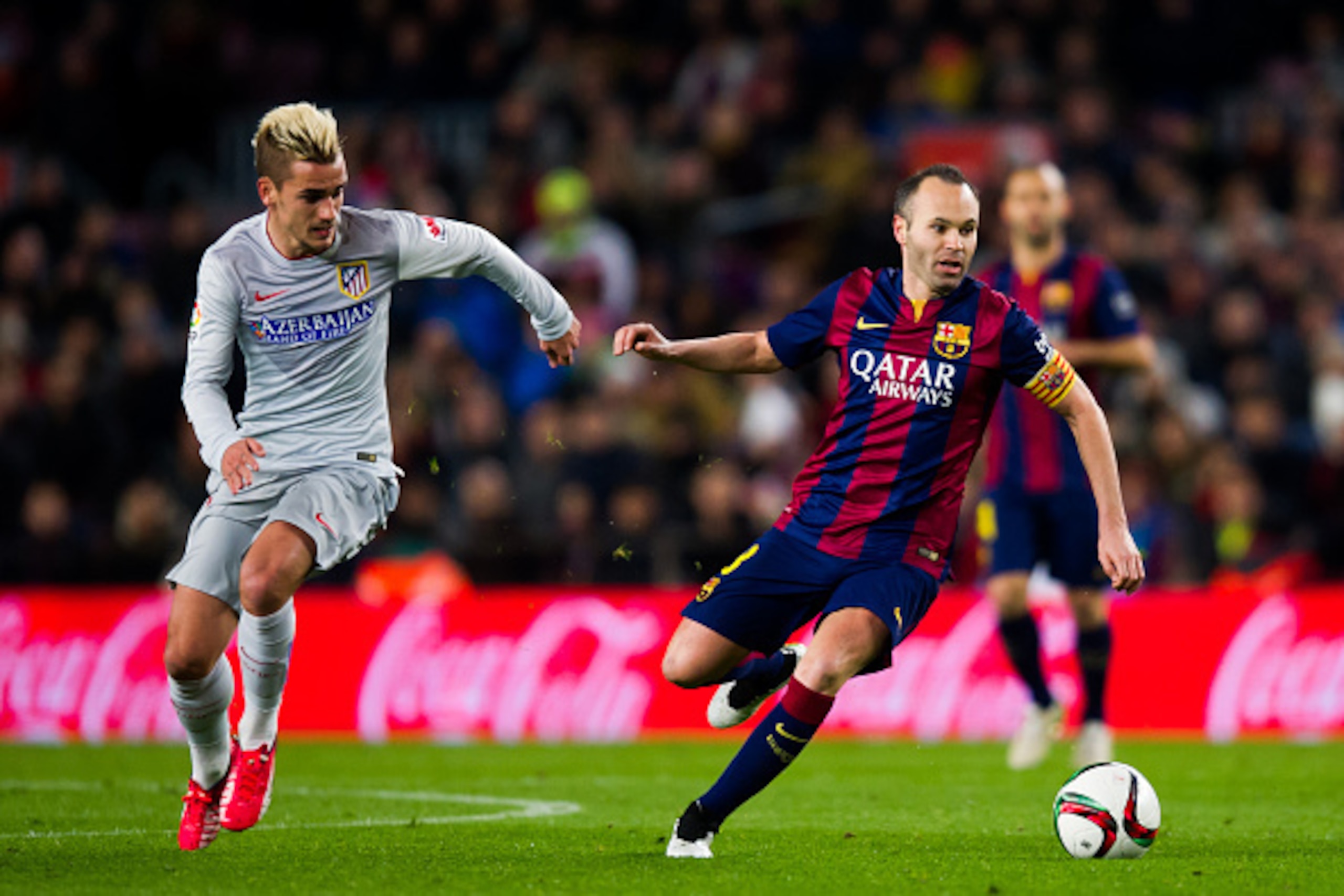 BARCELONA, SPAIN - JANUARY 21: Andres Iniesta (R) of FC Barcelona conducts the ball close to Antoine Griezmann of Club Atletico de Madrid during the Copa del Rey Quarter-Final First Leg match between FC Barcelona and Club Atletico de Madrid at Camp Nou o BARCELONA, SPAIN - JANUARY 21: Andres Iniesta (R) of FC Barcelona conducts the ball close to Antoine Griezmann of Club Atletico de Madrid during the Copa del Rey Quarter-Final First Leg match between FC Barcelona and Club Atletico de Madrid at Camp Nou o