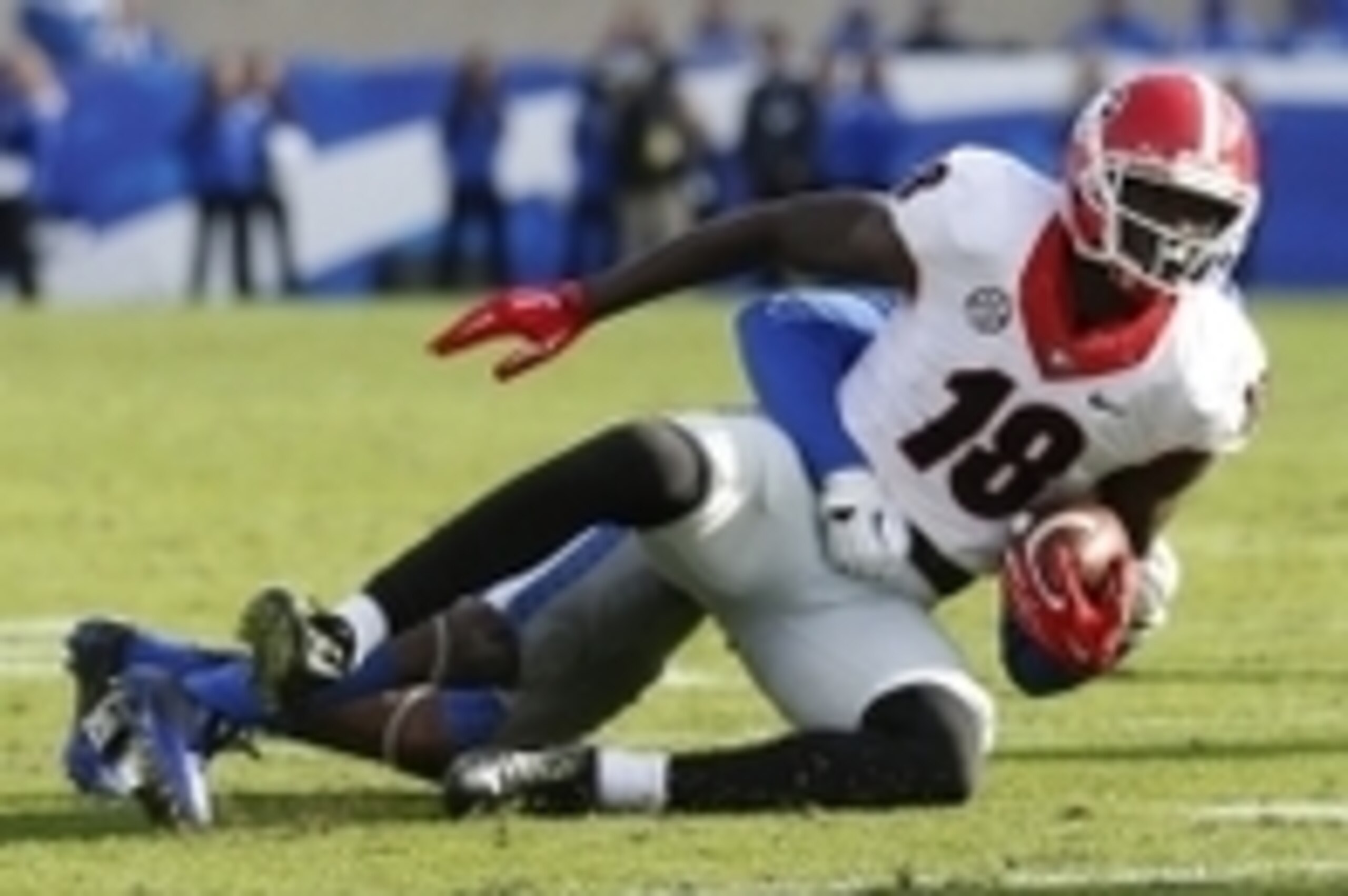 Nov 8, 2014; Lexington, KY, USA; Kentucky Wildcats safety A.J. Stamps (1) tackles Georgia Bulldogs split end Jonathon Rumph (18) at Commonwealth Stadium. Georgia defeated Kentucky 63-31. Mandatory Credit: Mark Zerof-USA TODAY Sports Nov 8, 2014; Lexington, KY, USA; Kentucky Wildcats safety A.J. Stamps (1) tackles Georgia Bulldogs split end Jonathon Rumph (18) at Commonwealth Stadium. Georgia defeated Kentucky 63-31. Mandatory Credit: Mark Zerof-USA TODAY Sports