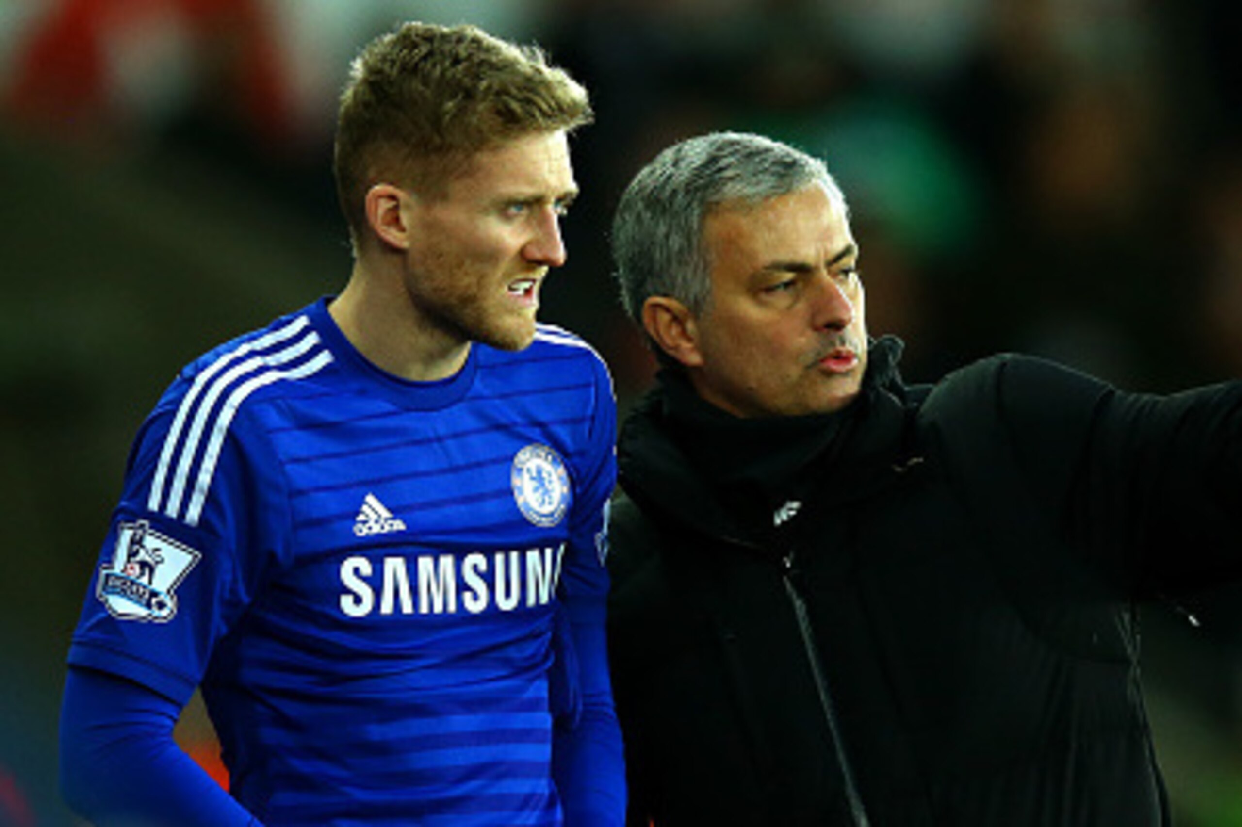 SWANSEA, WALES - JANUARY 17:  Jose Mourinho, manager of Chelsea speaks with Andre Schuerrle of Chelsea as he prepares to gon on during the Barclays Premier League match between Swansea City and Chelsea at Liberty Stadium on January 17, 2015 in Swansea, Wa