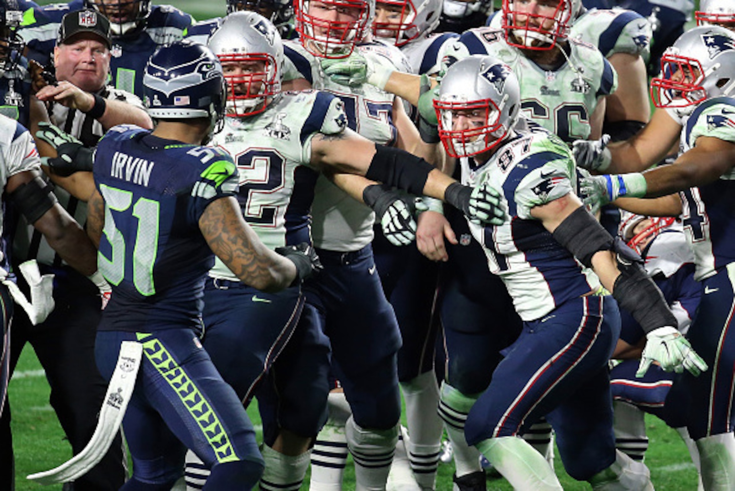 GLENDALE, AZ - FEBRUARY 01:  Bruce Irvin #51 of the Seattle Seahawks and  Rob Gronkowski #87 of the New England Patriots exchange words late in the fourth quarter during Super Bowl XLIX at University of Phoenix Stadium on February 1, 2015 in Glendale, Ari