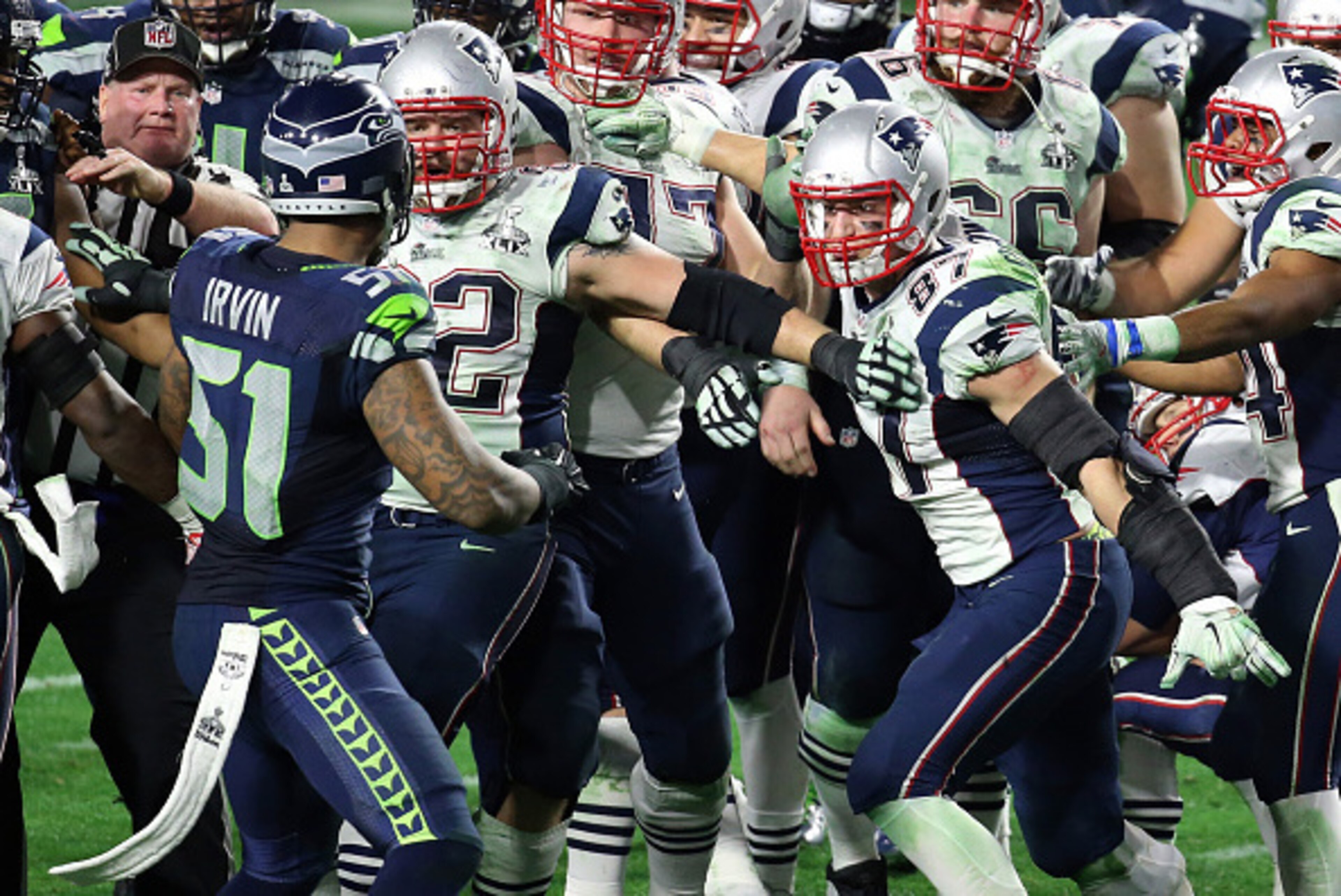 GLENDALE, AZ - FEBRUARY 01:  Bruce Irvin #51 of the Seattle Seahawks and  Rob Gronkowski #87 of the New England Patriots exchange words late in the fourth quarter during Super Bowl XLIX at University of Phoenix Stadium on February 1, 2015 in Glendale, Ari