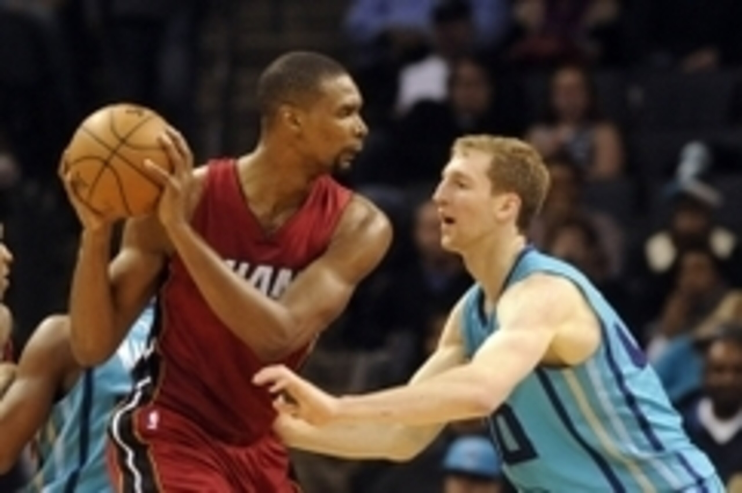 Jan 21, 2015; Charlotte, NC, USA; Miami Heat forward center Chris Bosh (1) looks to pass the ball as he is defended by Charlotte Hornets forward Cody Zeller (40) during the second half of the game at Time Warner Cable Arena. Hornets win 78-76. Mandatory C