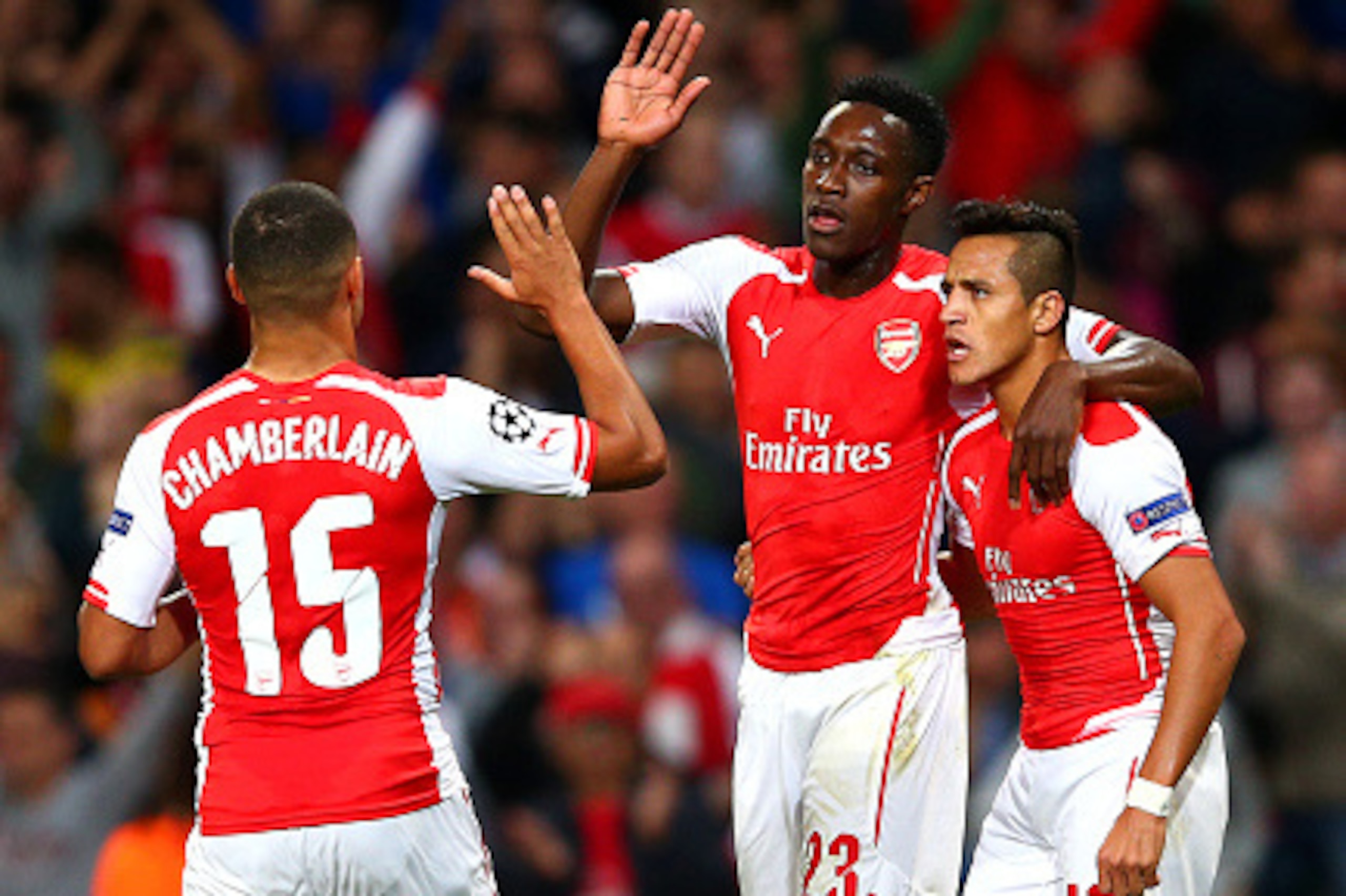 LONDON, ENGLAND - OCTOBER 01:  Danny Welbeck of Arsenal celebrates with team-mates Alex Oxlade-Chamberlain and Alexis Sanchez after scoring the opening goal during the UEFA Champions League group D match between Arsenal FC and Galatasaray AS at Emirates S