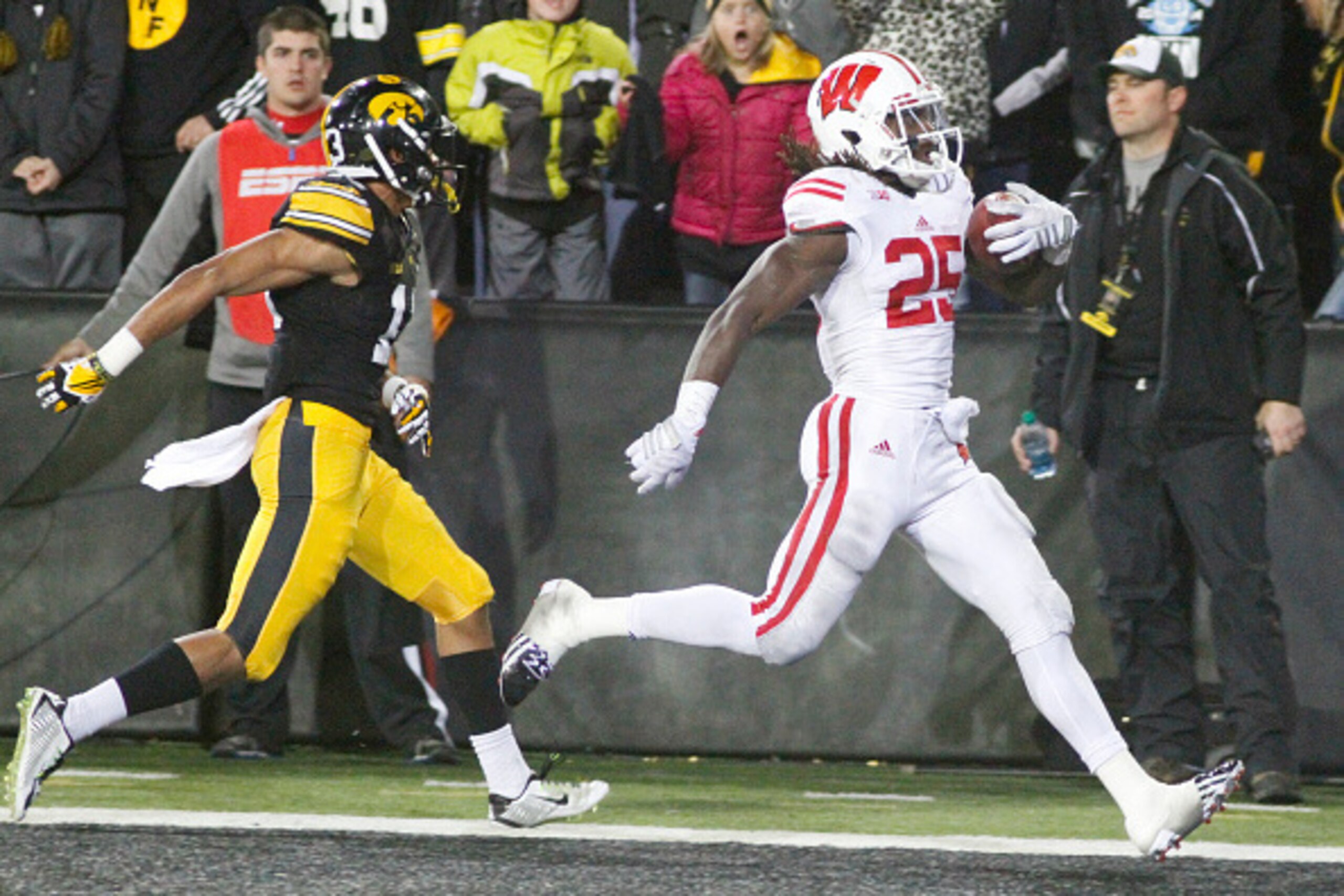 IOWA CITY, IA - NOVEMBER 22: Running back Melvin Gordon #25 of the Wisconsin Badgers runs in for a touchdown in front of defensive back Greg Mabin #13 of the Iowa Hawkeyes, in the fourth quarter on November 22, 2014 at Kinnick Stadium, in Iowa City, Iowa. IOWA CITY, IA - NOVEMBER 22: Running back Melvin Gordon #25 of the Wisconsin Badgers runs in for a touchdown in front of defensive back Greg Mabin #13 of the Iowa Hawkeyes, in the fourth quarter on November 22, 2014 at Kinnick Stadium, in Iowa City, Iowa.