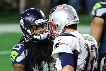 GLENDALE, AZ - FEBRUARY 01:  Richard Sherman #25 of the Seattle Seahawks and  Tom Brady #12 of the New England Patriots speak late in the fourth quarter during Super Bowl XLIX at University of Phoenix Stadium on February 1, 2015 in Glendale, Arizona.  (Ph