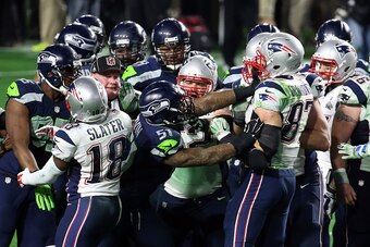 GLENDALE, AZ - FEBRUARY 01:  Bruce Irvin #51 of the Seattle Seahawks and  Rob Gronkowski #87 of the New England Patriots exchange words after a play late in the game during Super Bowl XLIX at University of Phoenix Stadium on February 1, 2015 in Glendale, 