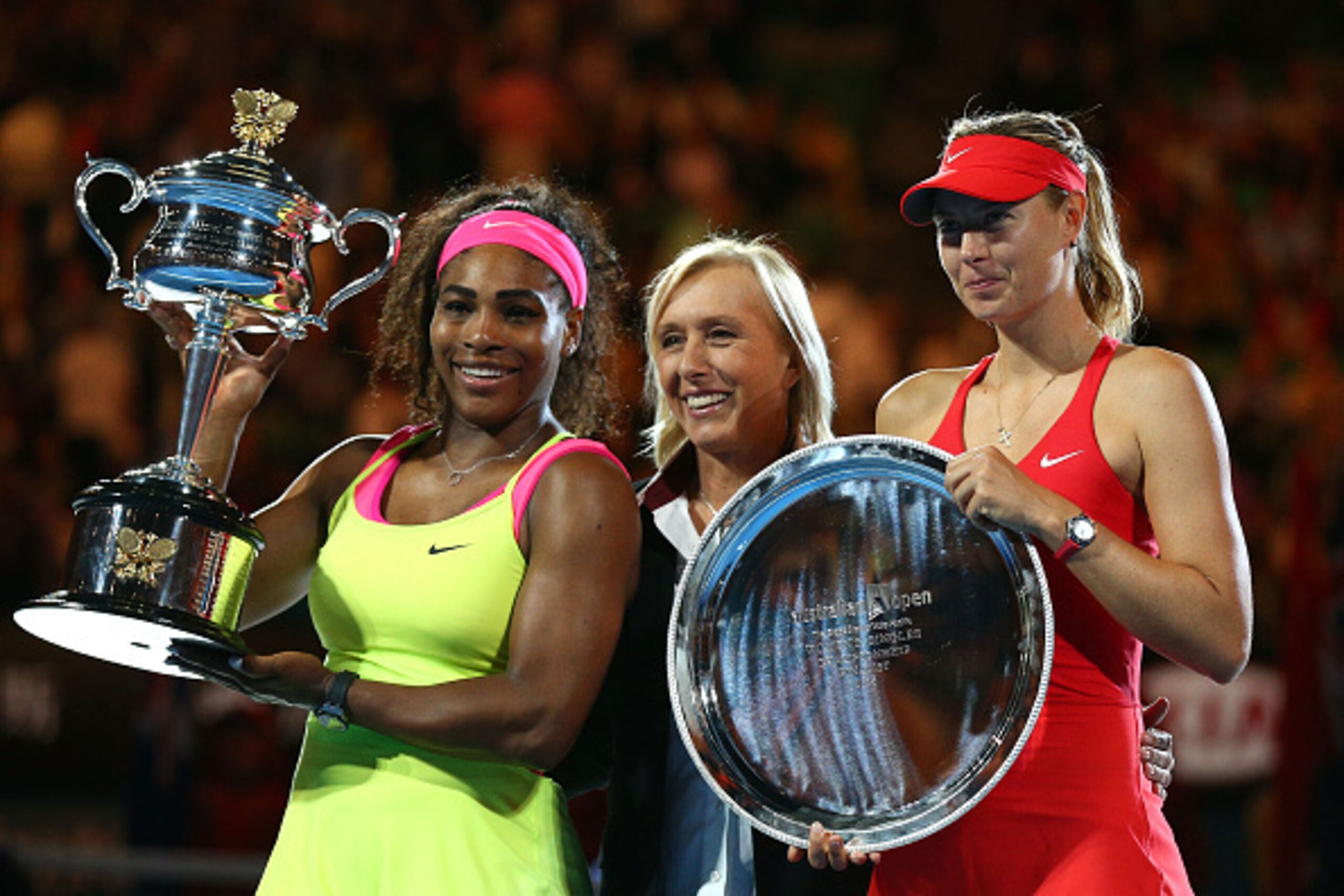 MELBOURNE, AUSTRALIA - JANUARY 31:  Martina Navratilova poses with Serena Williams of the United States holds the Daphne Akhurst Memorial Cup and Maria Sharapova of Russia holds the runner up plate afte their women's final match during day 13 of the 2015 