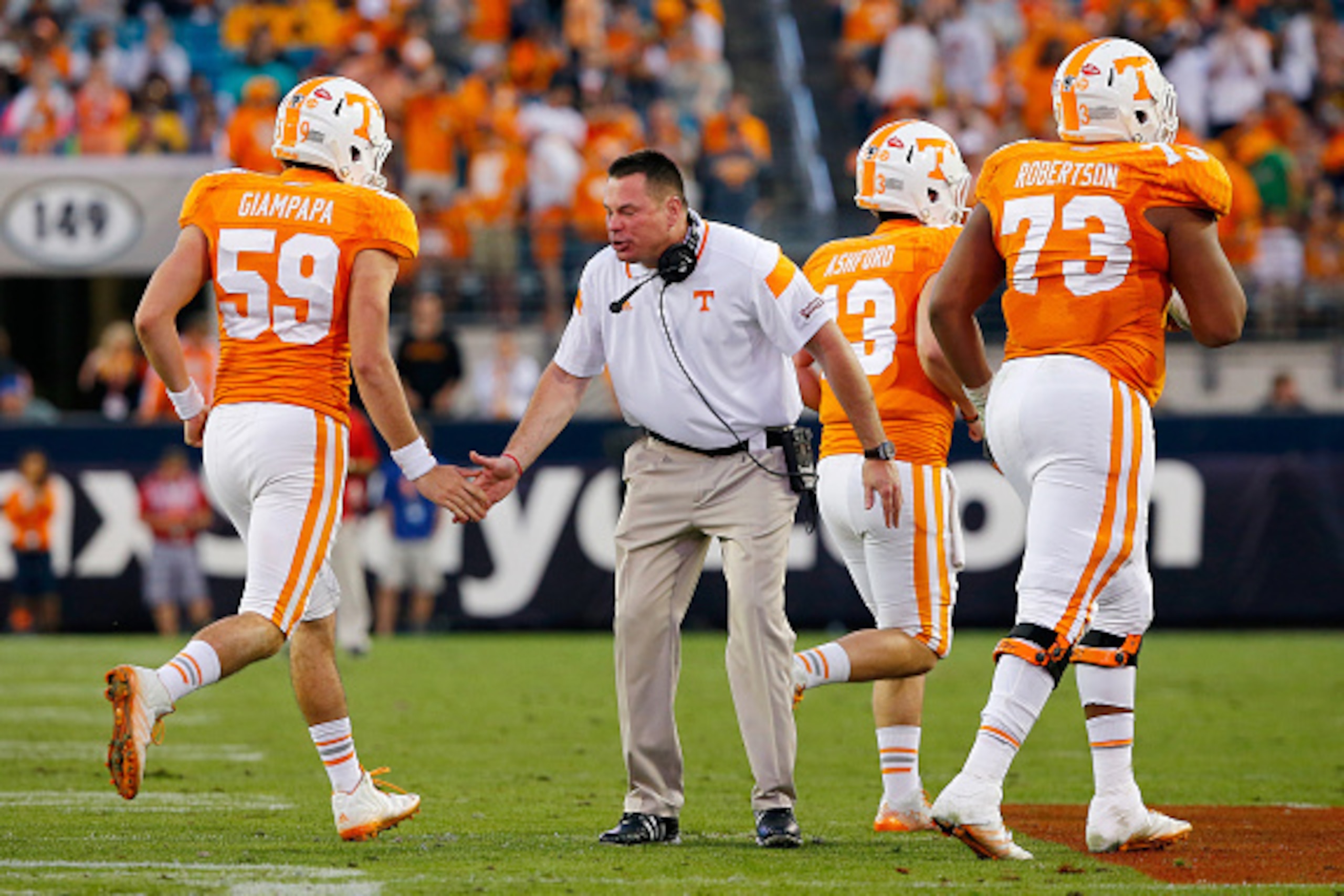 JACKSONVILLE, FL - JANUARY 02:  Head coach Butch Jones of the Tennessee Volunteers celebrates with players during the TaxSlayer Bowl against the Iowa Hawkeyes at EverBank Field on January 2, 2015 in Jacksonville, Florida.  The Tennessee Volunteers defeate