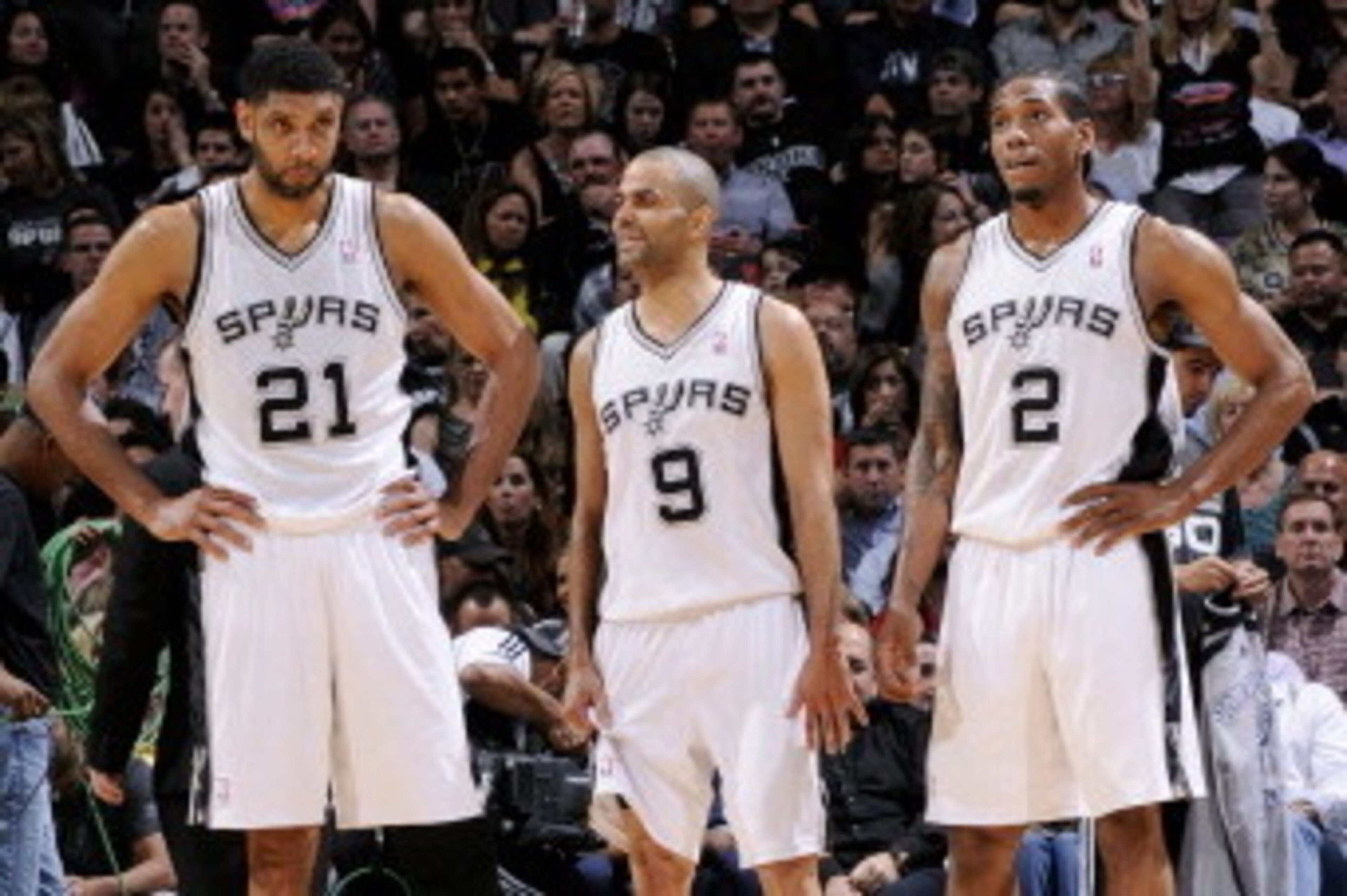 SAN ANTONIO, TX - MAY 14: Tim Duncan #21, Tony Parker #9, and Kawhi Leonard #2 of the San Antonio Spurs stand on the court during a game against the Portland Trail Blazers in Game Five of the Western Conference Semifinals between the San Antonio Spurs and