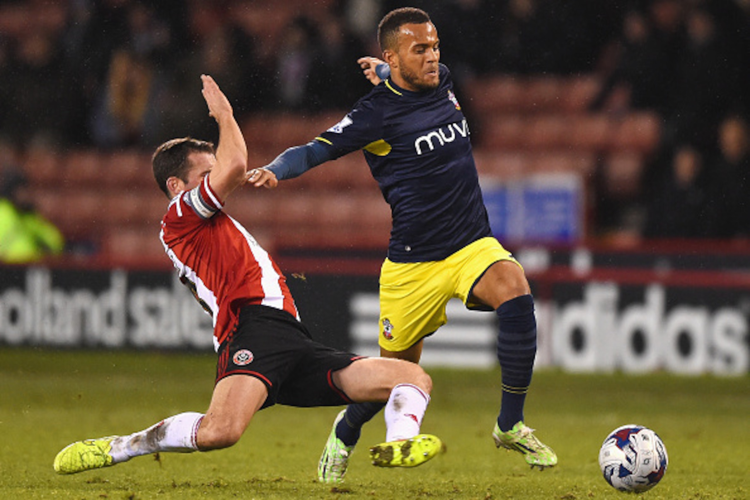 SHEFFIELD, ENGLAND - DECEMBER 16: Ryan Bertrand of Southampton is tackled by Michael Doyle of Sheffield United during the Capital One Cup Quarter-Final match between Sheffield United and Southampton at Bramall Lane on December 16, 2014 in Sheffield, Engla