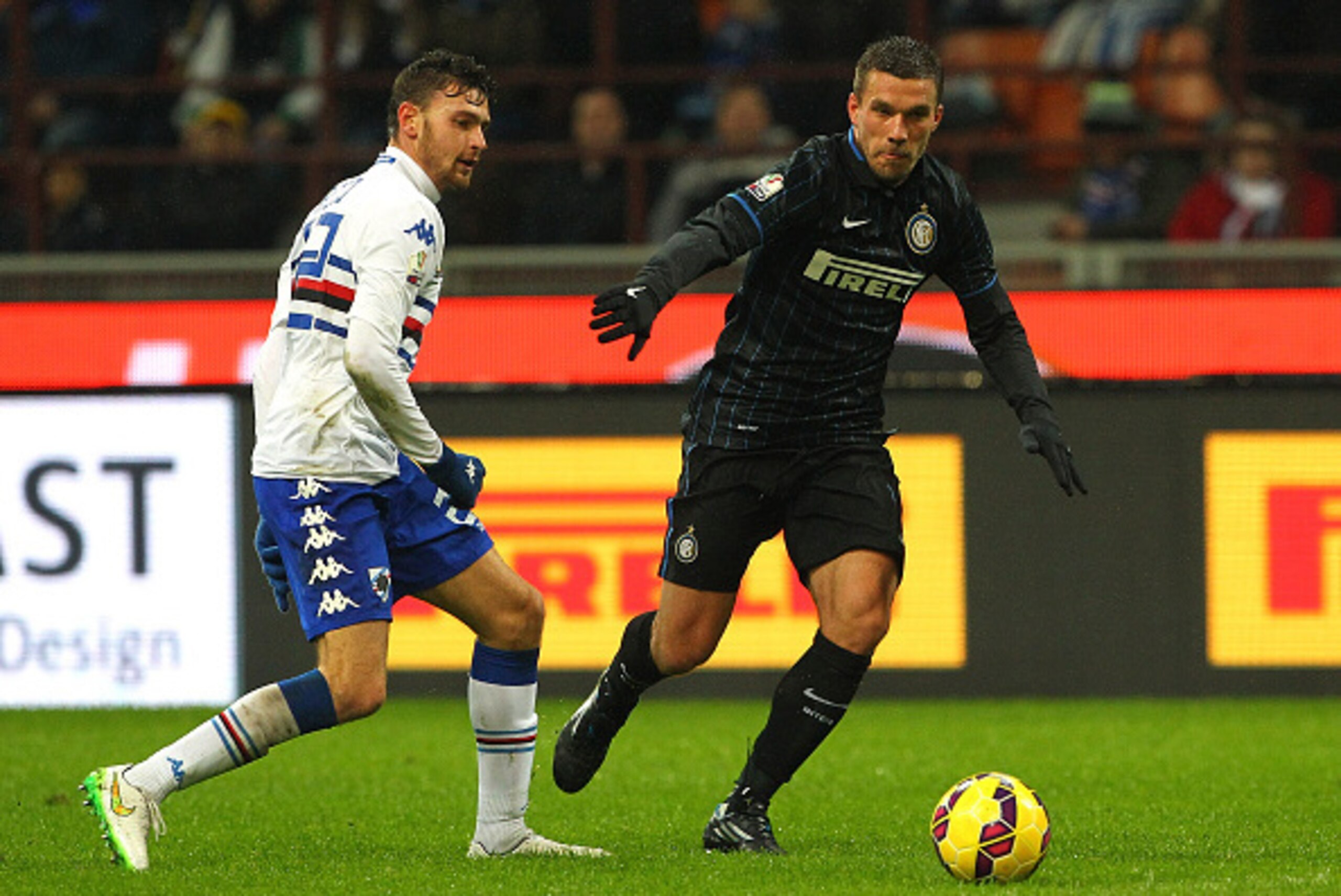 MILAN, ITALY - JANUARY 21: Lukas Podolski (R) of FC Internazionale Milano is challenged by with Luca Rizzo (L) of UC Sampdoria during the TIM Cup match between FC Internazionale Milano and UC Sampdoria at Stadio Giuseppe Meazza on January 21, 2015 in Mil MILAN, ITALY - JANUARY 21: Lukas Podolski (R) of FC Internazionale Milano is challenged by with Luca Rizzo (L) of UC Sampdoria during the TIM Cup match between FC Internazionale Milano and UC Sampdoria at Stadio Giuseppe Meazza on January 21, 2015 in Mil