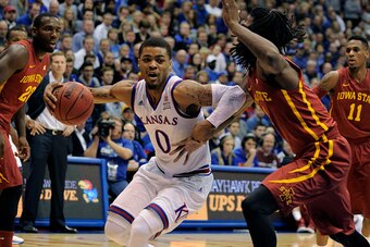 LAWRENCE, KS - FEBRUARY 2:  Frank Mason III #0 of the Kansas Jayhawks drives the lane against Jameel McKay #1 of the Iowa State Cyclones in the first half at Allen Field House on February 2, 2015 in Lawrence, Kansas. (Photo by Ed Zurga/Getty Images)