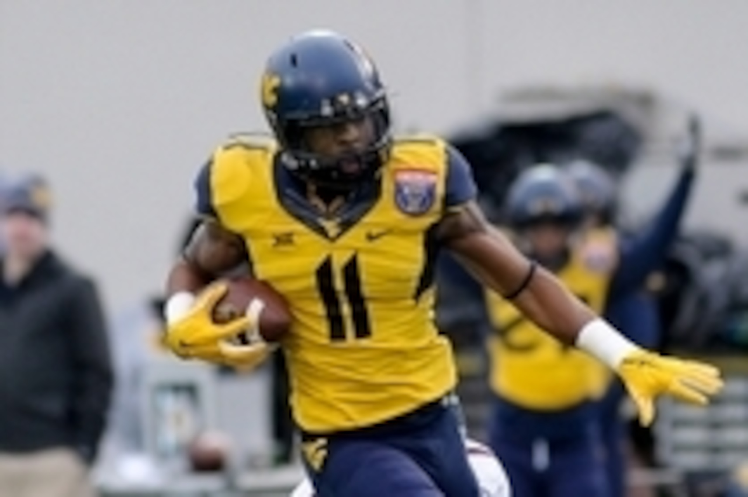 Dec 29, 2014; Memphis, TN, USA; West Virginia Mountaineers wide receiver Kevin White (11) is tackled by Texas A&M Aggies defensive back De'Vante Harris (1) during the game in the 2014 Liberty Bowl at Liberty Bowl Memorial Stadium. Texas A&M Aggies beat We