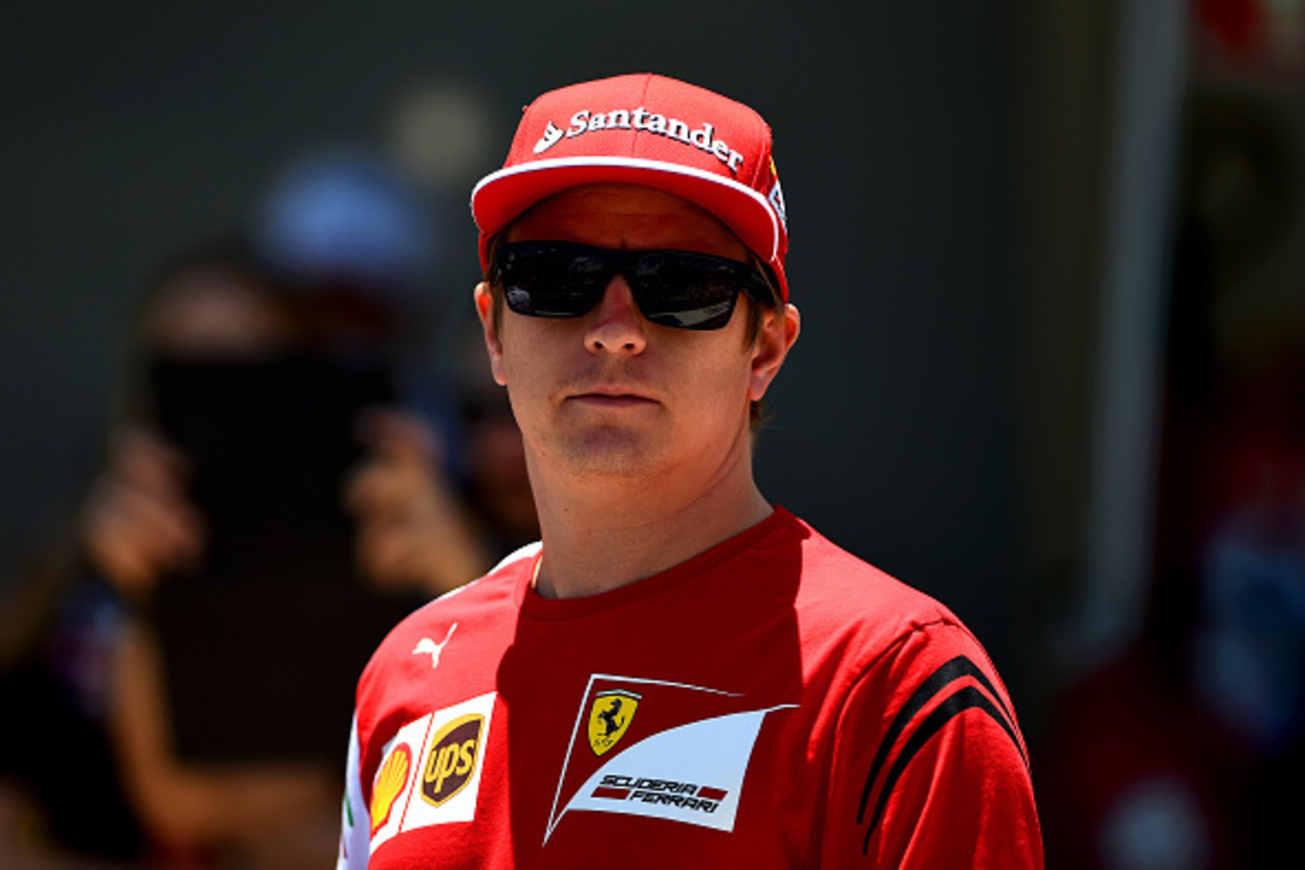 SAO PAULO, BRAZIL - NOVEMBER 09:  Kimi Raikkonen of Finland and Ferrari walks out for the drivers' parade before the Brazilian Formula One Grand Prix at Autodromo Jose Carlos Pace on November 9, 2014 in Sao Paulo, Brazil.  (Photo by Paul Gilham/Getty Imag