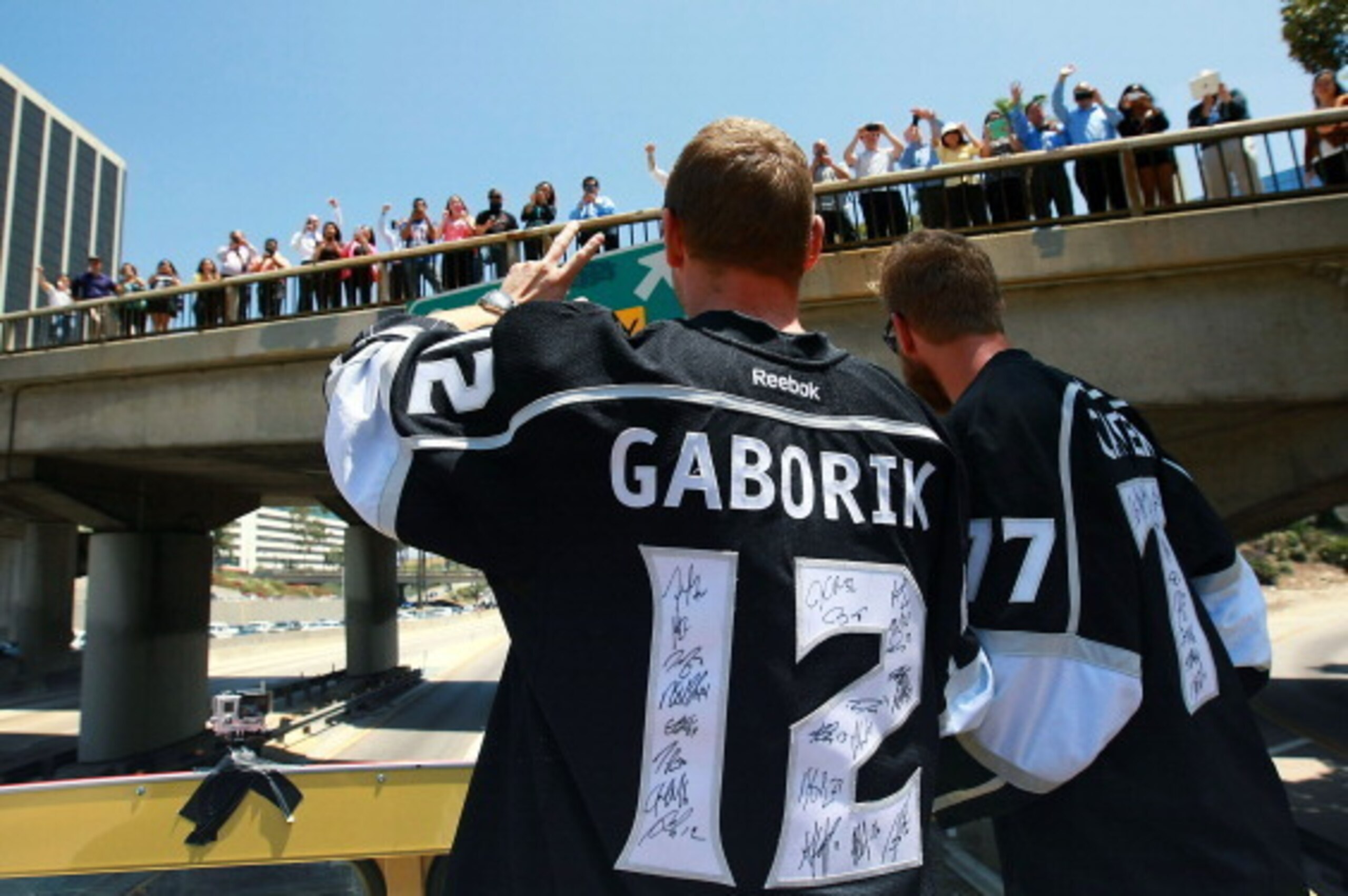 LOS ANGELES, CA- JUNE 16:  Marian Gaborik #12 and Jeff Carter #77 of the Los Angeles Kings wave to fans during the 2014 LA Kings Stanley Cup Championship Parade and Rally on June 16, 2014 in Los Angeles, California.  (Photo by Dave Sandford/Getty Images)