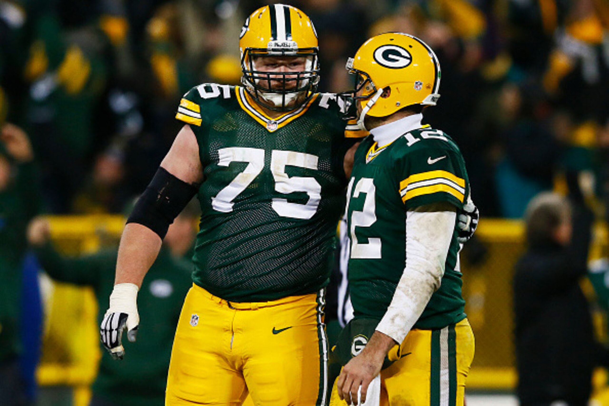 GREEN BAY, WI - DECEMBER 08:   Aaron Rodgers #12 and  Bryan Bulaga #75 of the Green Bay Packers reacts against the Atlanta Falcons at Lambeau Field on December 8, 2014 in Green Bay, Wisconsin.  (Photo by Kevin C. Cox/Getty Images)