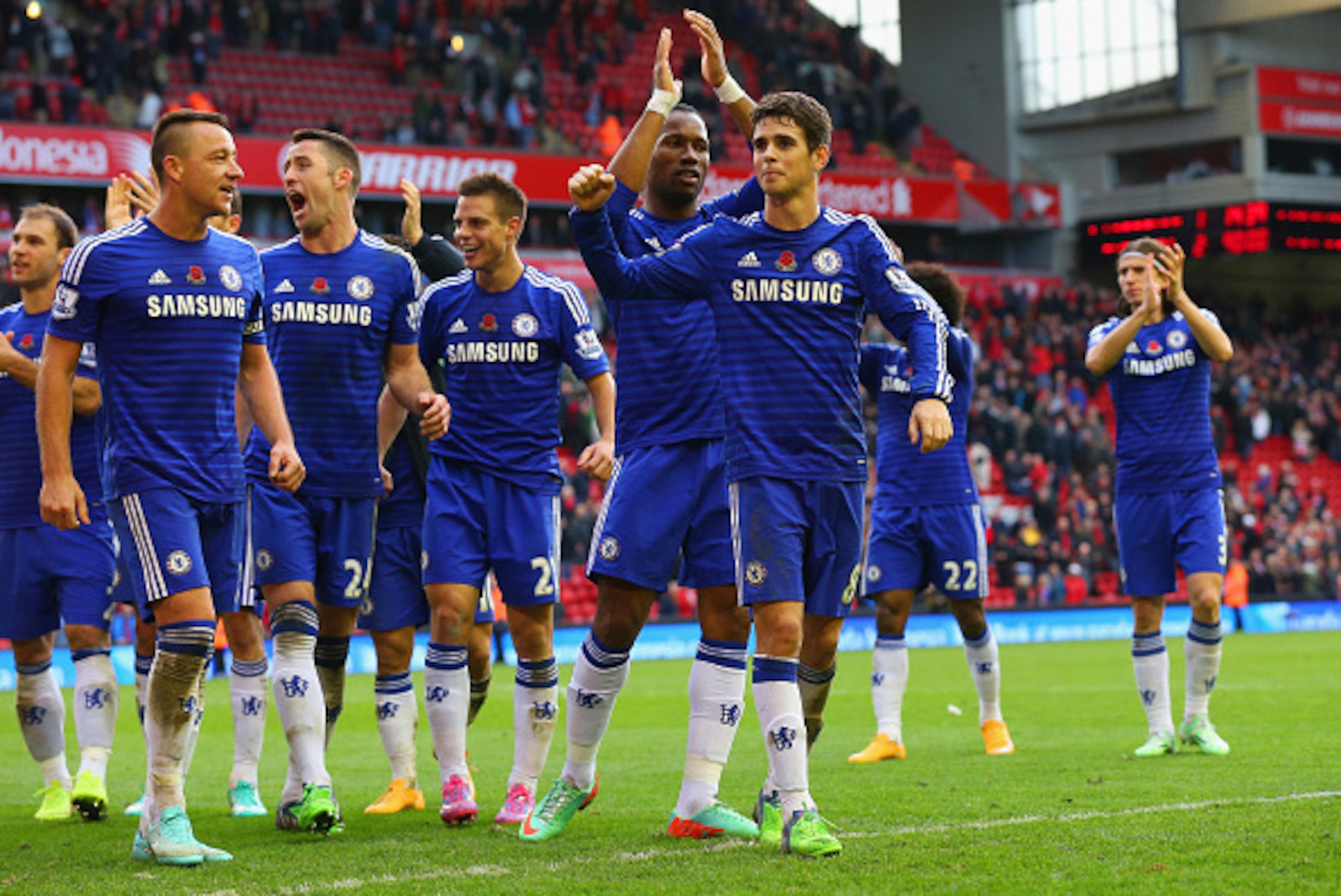 LIVERPOOL, ENGLAND - NOVEMBER 08: John Terry, Gary Cahill, Didier Drogba and Oscar of Chelsea celebrate victory after the Barclays Premier League match between Liverpool and Chelsea at Anfield on November 8, 2014 in Liverpool, England.  (Photo by Alex Liv