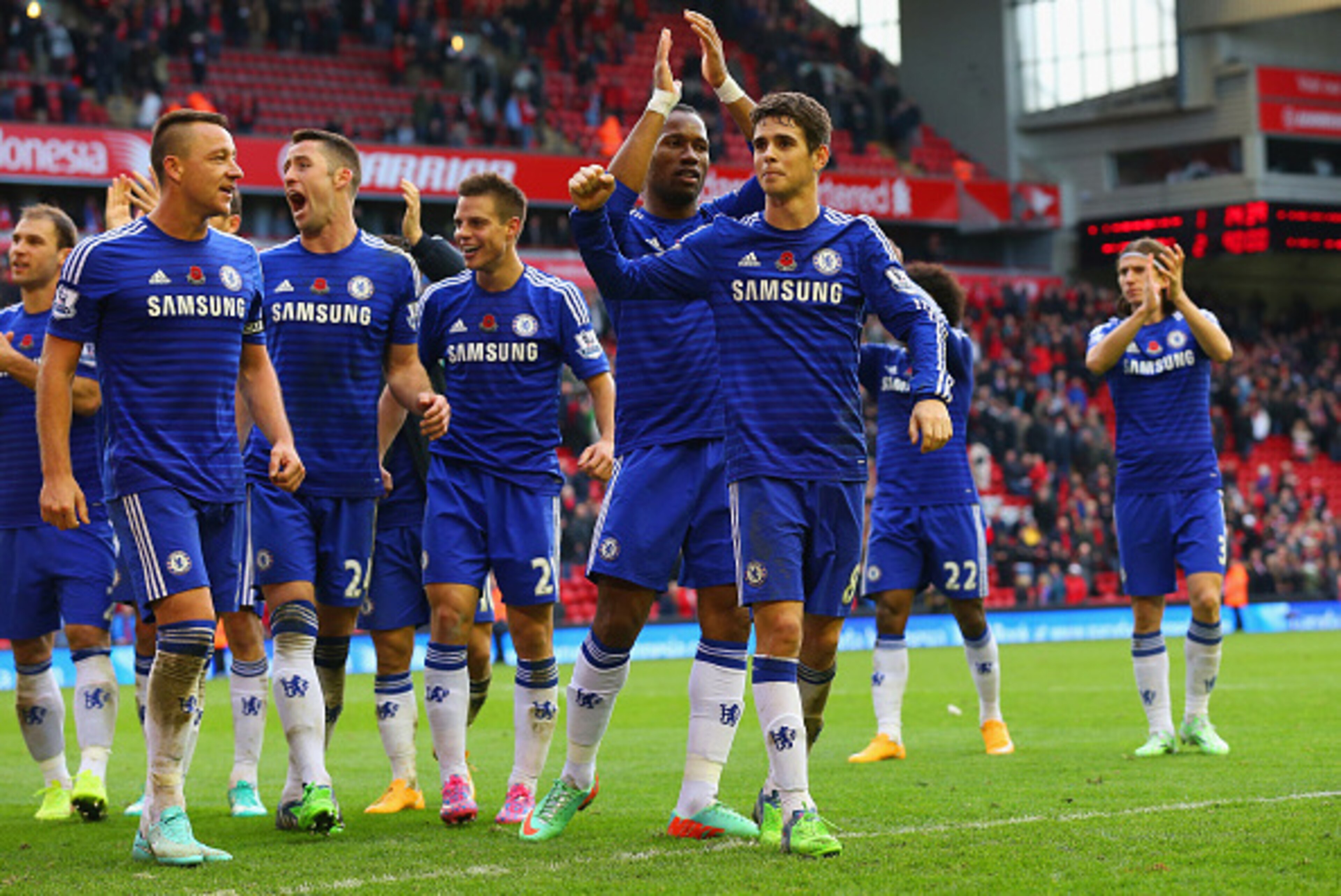 LIVERPOOL, ENGLAND - NOVEMBER 08: John Terry, Gary Cahill, Didier Drogba and Oscar of Chelsea celebrate victory after the Barclays Premier League match between Liverpool and Chelsea at Anfield on November 8, 2014 in Liverpool, England.  (Photo by Alex Liv