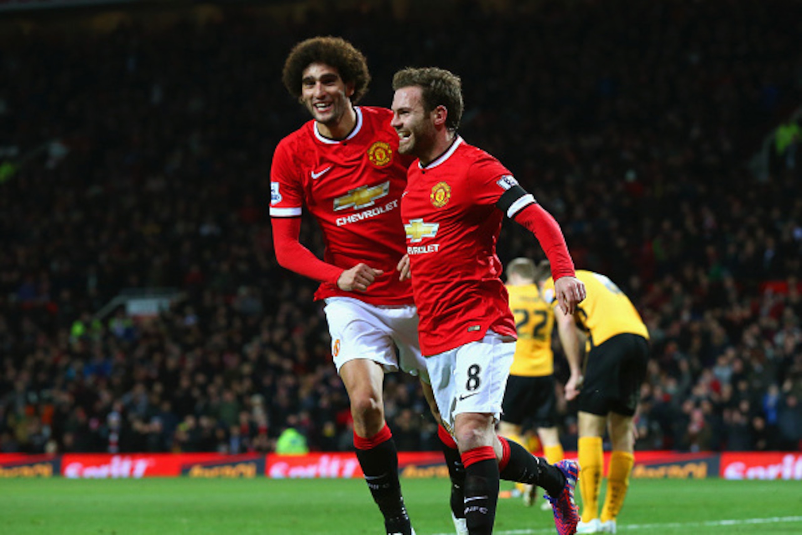 MANCHESTER, ENGLAND - FEBRUARY 03:  Juan Mata of Manchester United celebrates scoring the opening goal with Marouane Fellaini of Manchester United during the FA Cup Fourth round replay match between Manchester United and Cambridge United at Old Trafford o