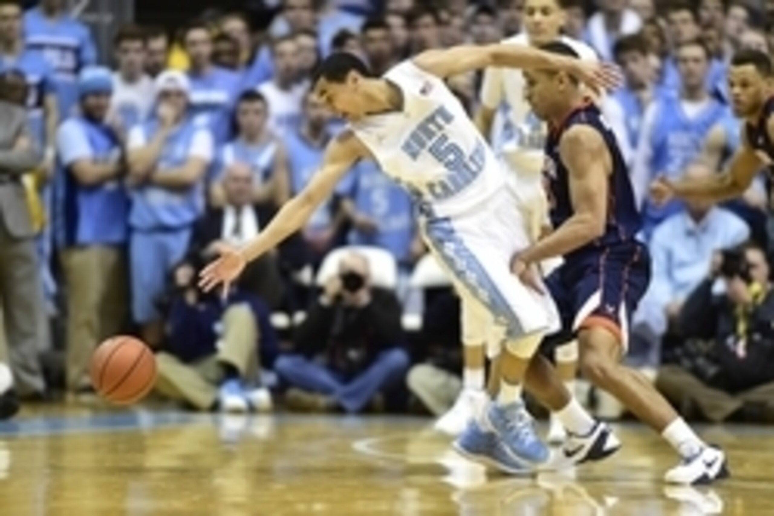 Feb 2, 2015; Chapel Hill, NC, USA; North Carolina Tar Heels guard Marcus Paige (5) reaches for the ball as Virginia Cavaliers guard Malcolm Brogdon (15) defends in the second half. The Cavaliers defeated the Tar Heels 75-64 at Dean E. Smith Center. Mandat Feb 2, 2015; Chapel Hill, NC, USA; North Carolina Tar Heels guard Marcus Paige (5) reaches for the ball as Virginia Cavaliers guard Malcolm Brogdon (15) defends in the second half. The Cavaliers defeated the Tar Heels 75-64 at Dean E. Smith Center. Mandat