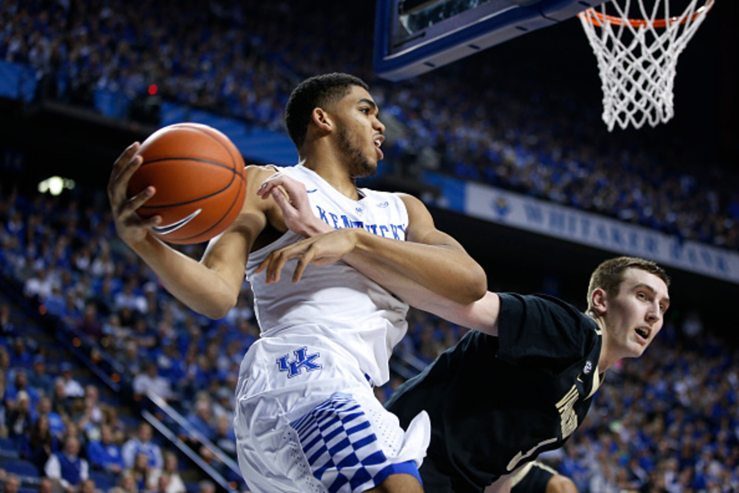 LEXINGTON, KY - JANUARY 20: Karl-Anthony Towns #12 of the Kentucky Wildcats goes to the basket against Luke Kornet #3 of the Vanderbilt Commodores during the game at Rupp Arena on January 20, 2015 in Lexington, Kentucky. Kentucky defeated Vanderbilt 65-57