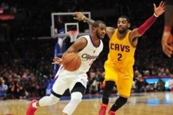 January 16, 2015; Los Angeles, CA, USA; Los Angeles Clippers guard Chris Paul (3) moves the ball against the defense of Cleveland Cavaliers guard Kyrie Irving (2) during the second half at Staples Center. Mandatory Credit: Gary A. Vasquez-USA TODAY Sports