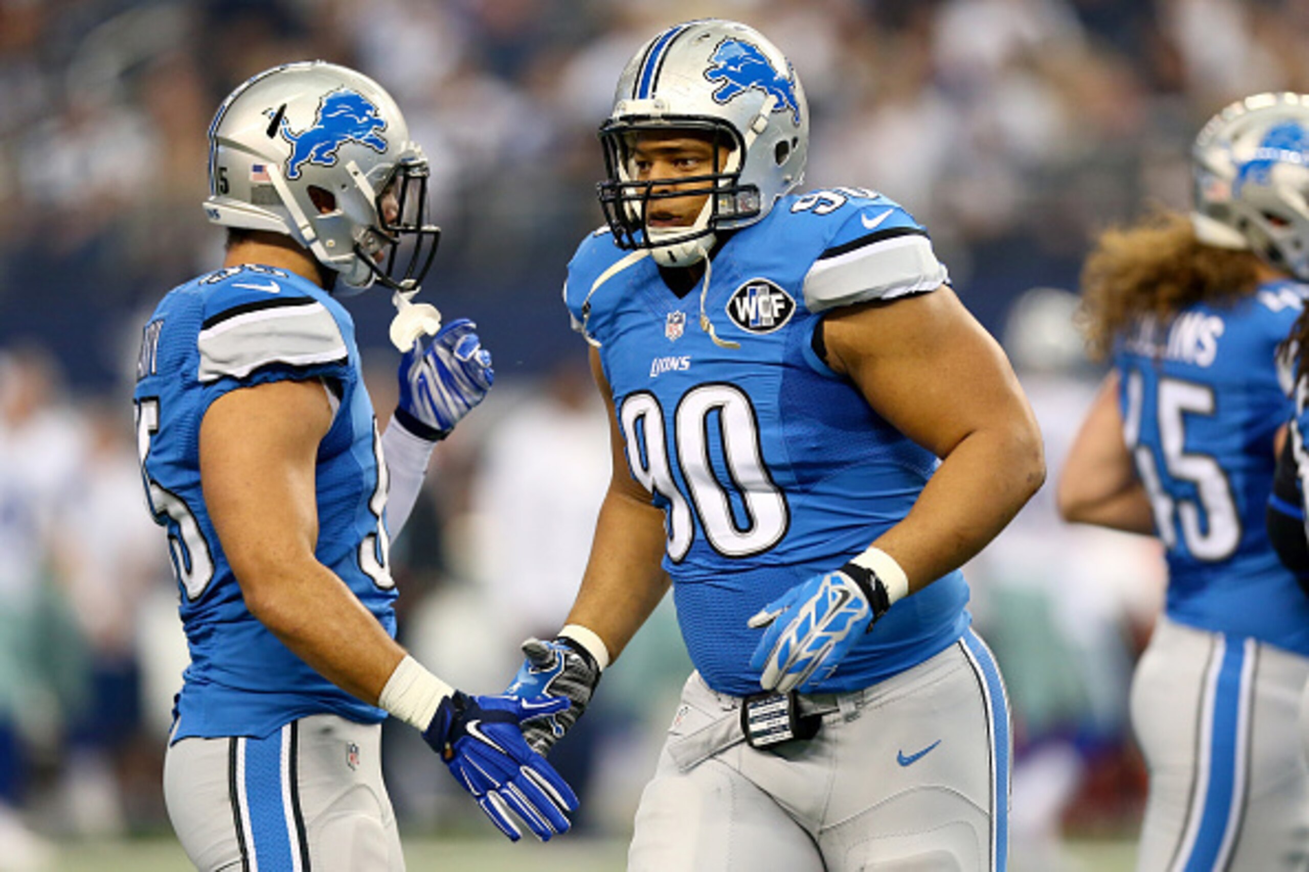 ARLINGTON, TX - JANUARY 04:  Defensive tackle Ndamukong Suh #90 of the Detroit Lions gives outside linebacker Kyle Van Noy #95 a five in the first quarter against the Dallas Cowboys during the NFC Wildcard Playoff Game at AT&T Stadium on January 4, 2015 i