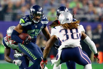 GLENDALE, AZ - FEBRUARY 01:   Bobby Wagner #54 of the Seattle Seahawks is faced by Brandon Bolden #38 of the New England Patriots as he runs with the ball in the third quarter during Super Bowl XLIX at University of Phoenix Stadium on February 1, 2015 in 
