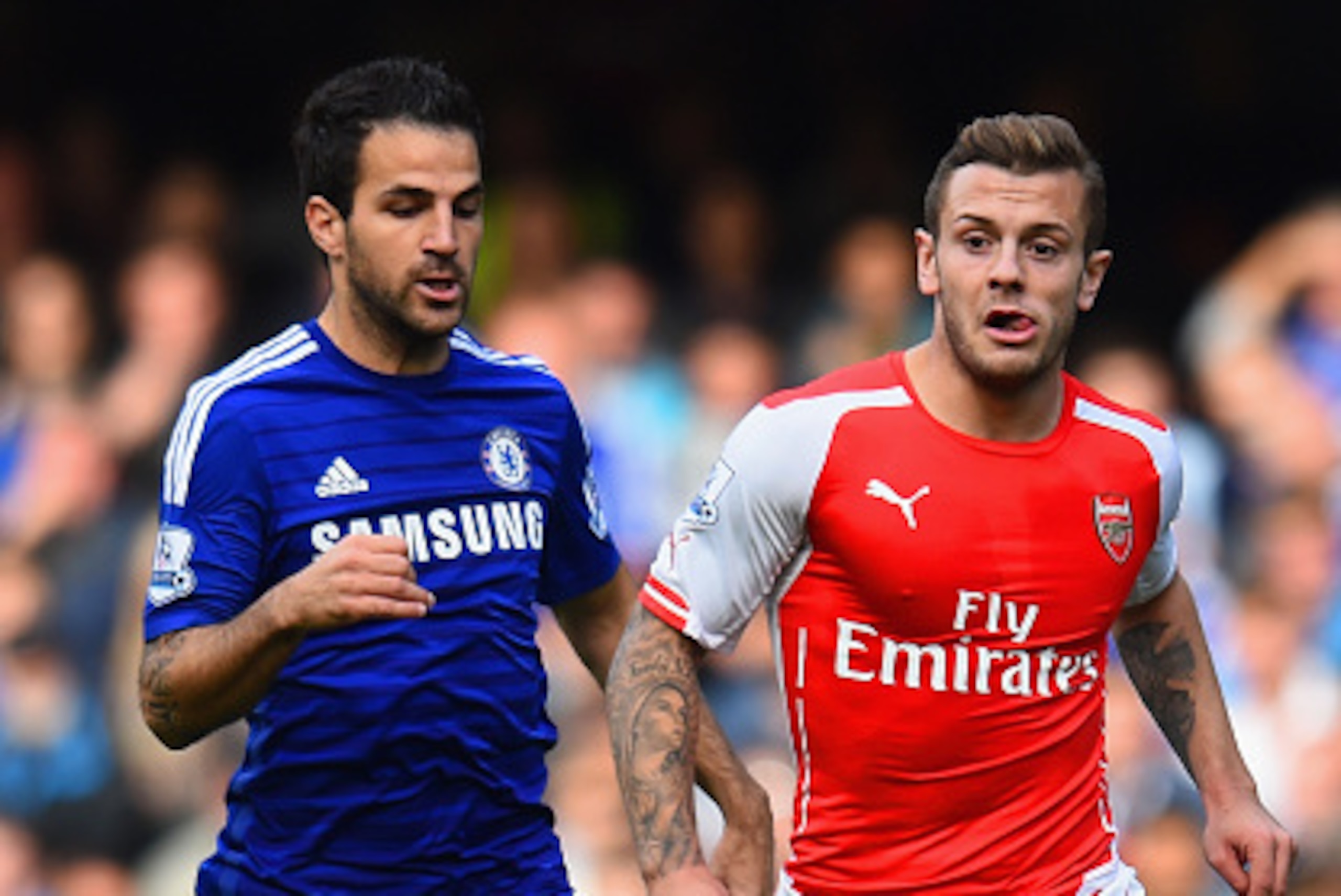 LONDON, ENGLAND - OCTOBER 05:  Cesc Fabregas of Chelsea and Jack Wilshere of Arsenal battle for the ball during the Barclays Premier League match between Chelsea and Arsenal at Stamford Bridge on October 4, 2014 in London, England.  (Photo by Shaun Botter