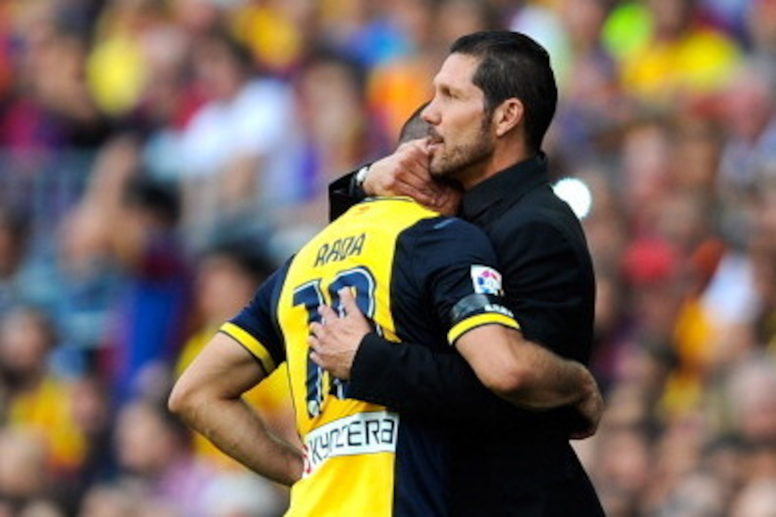 BARCELONA, SPAIN - MAY 17: Head coach Diego Pablo Simeone of Atletico de Madrid hugs his player Arda Turan as he leaves the pitch injured during the La Liga match between FC Barcelona and Club Atletico de Madrid at Camp Nou on May 17, 2014 in Barcelona, S